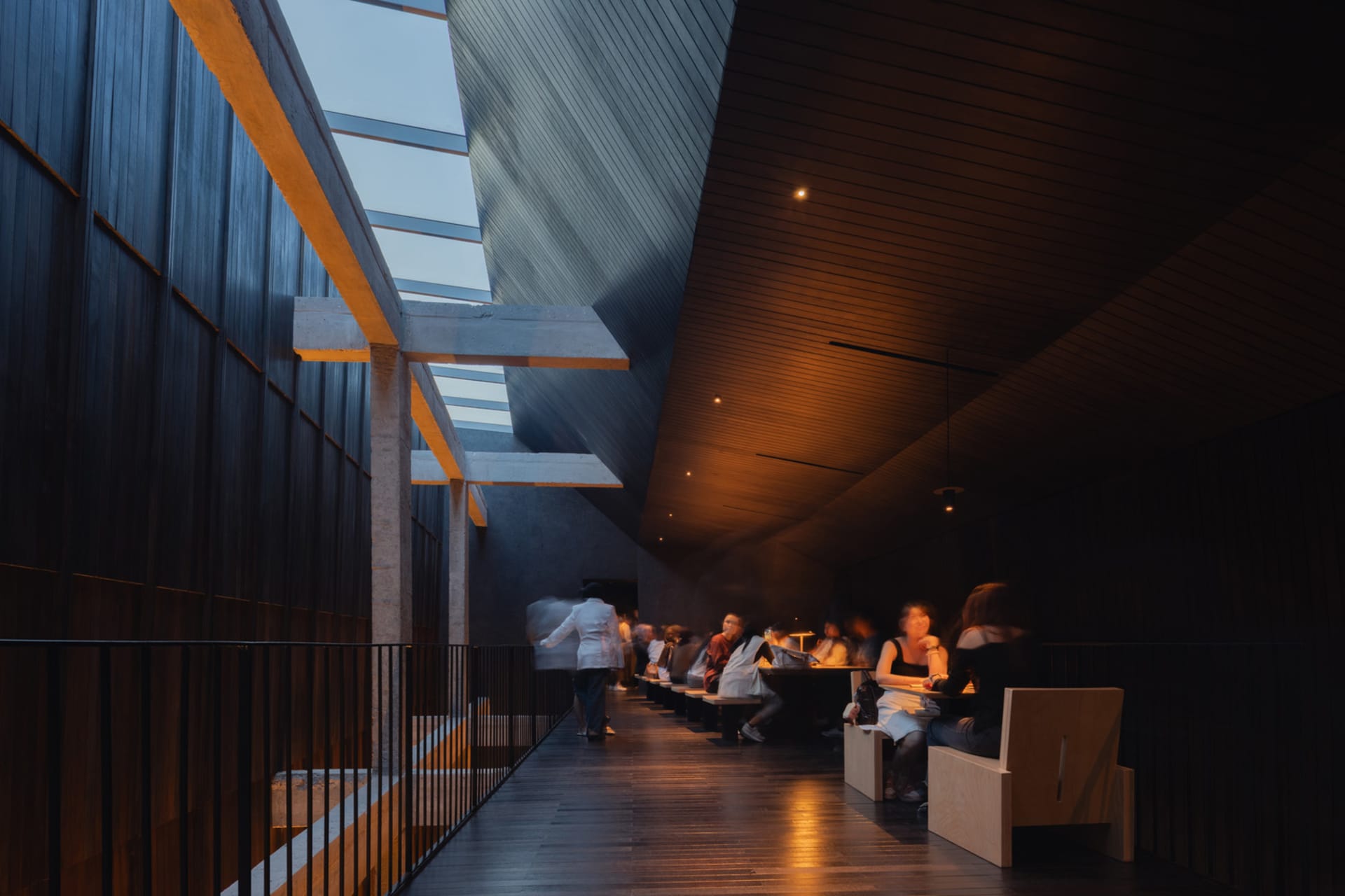 Interior of a modern restaurant featuring concrete and wooden elements