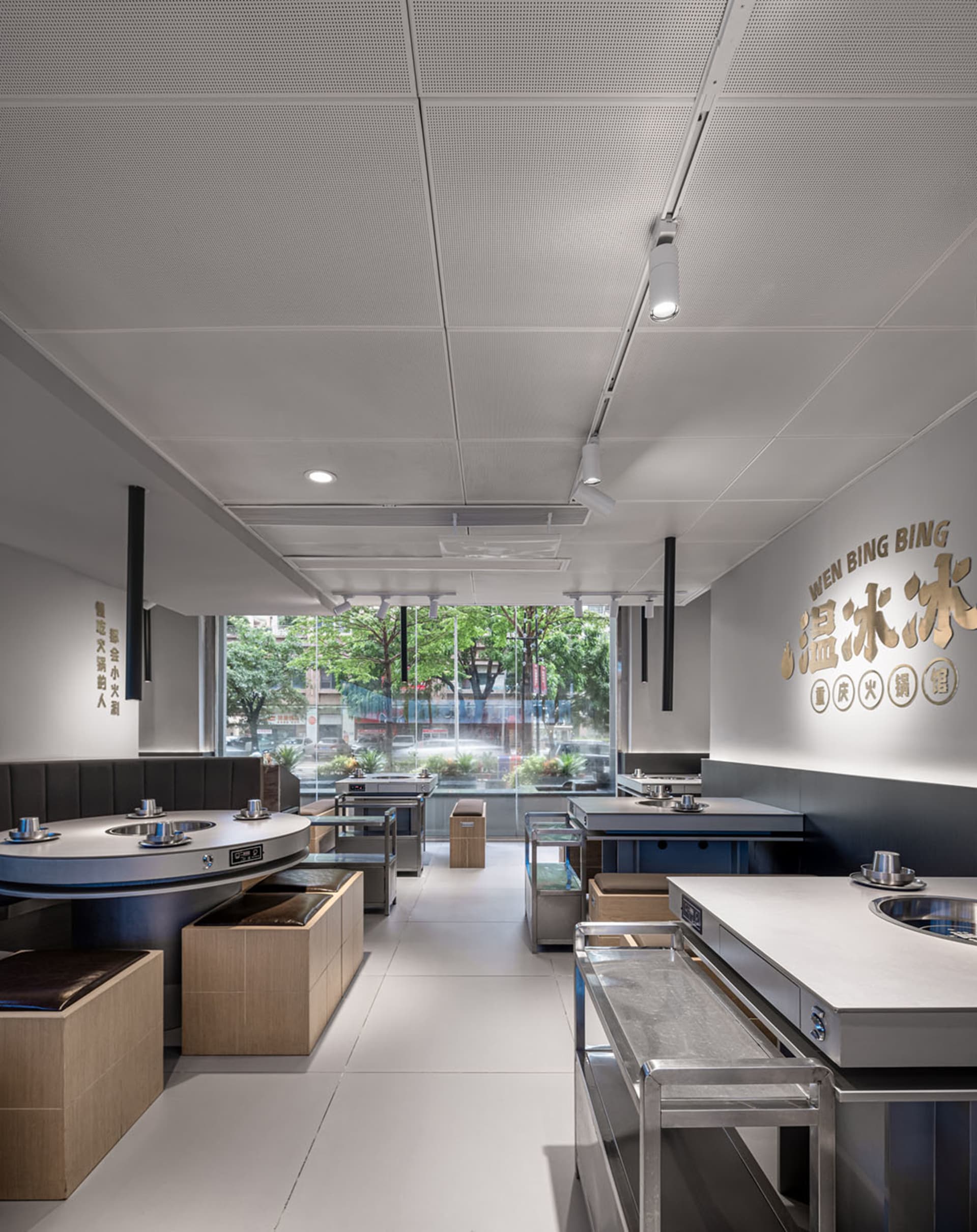 Modern restaurant interior with metallic tables and industrial design elements