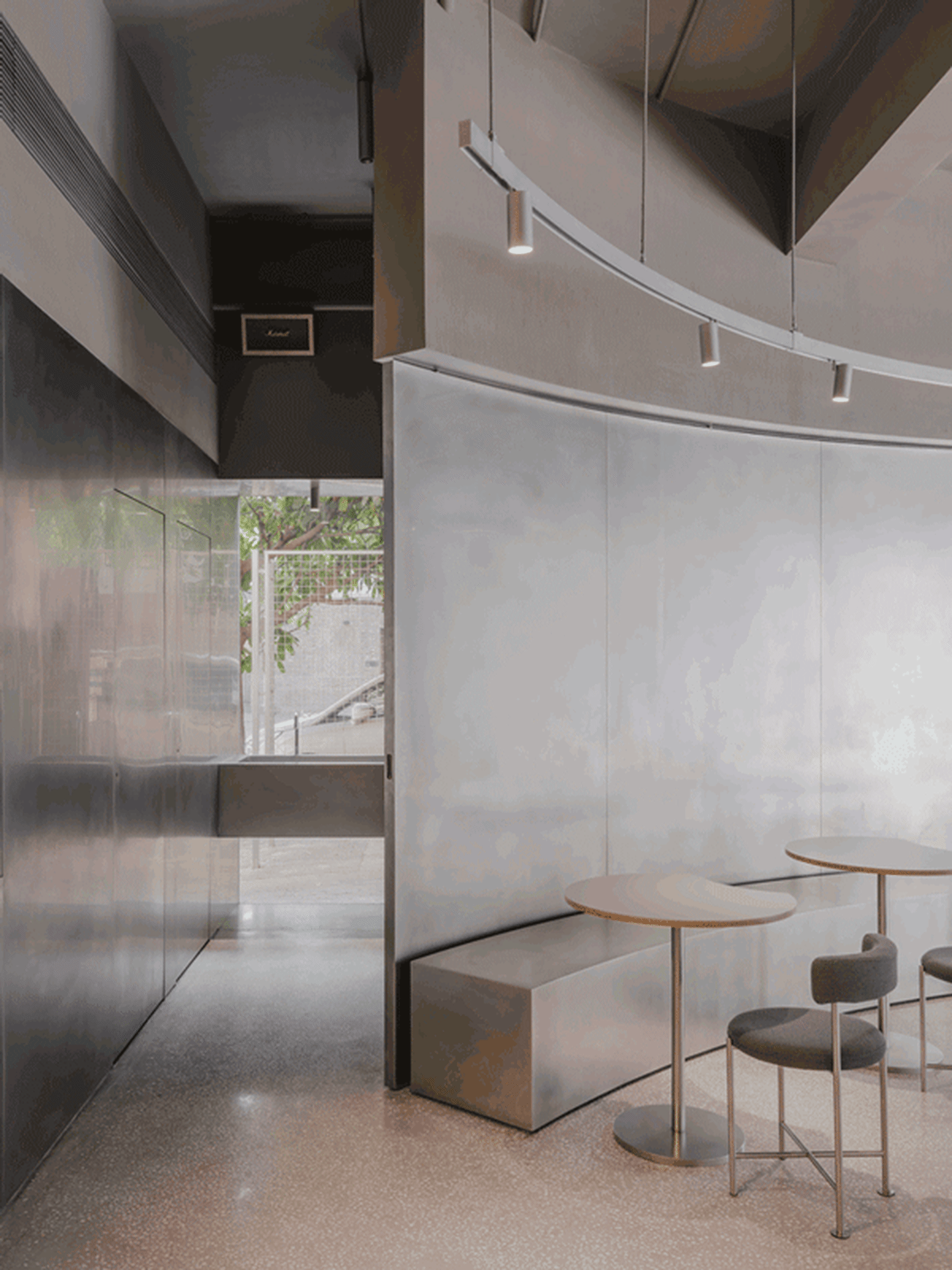 Modern minimalist cafe interior with metallic and glass materials