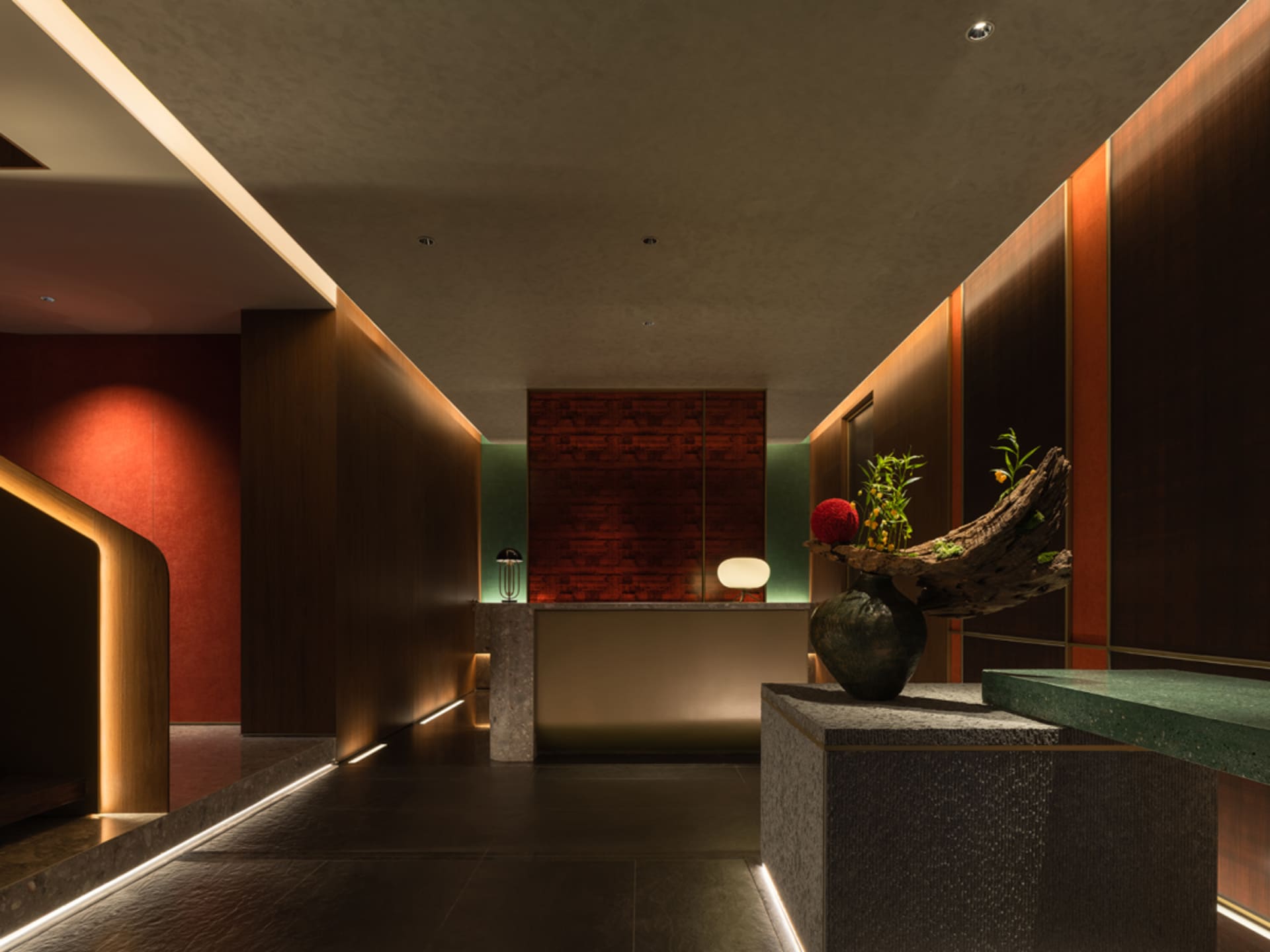 A modern interior design of a hotel front desk reception area featuring concrete and wood materials.