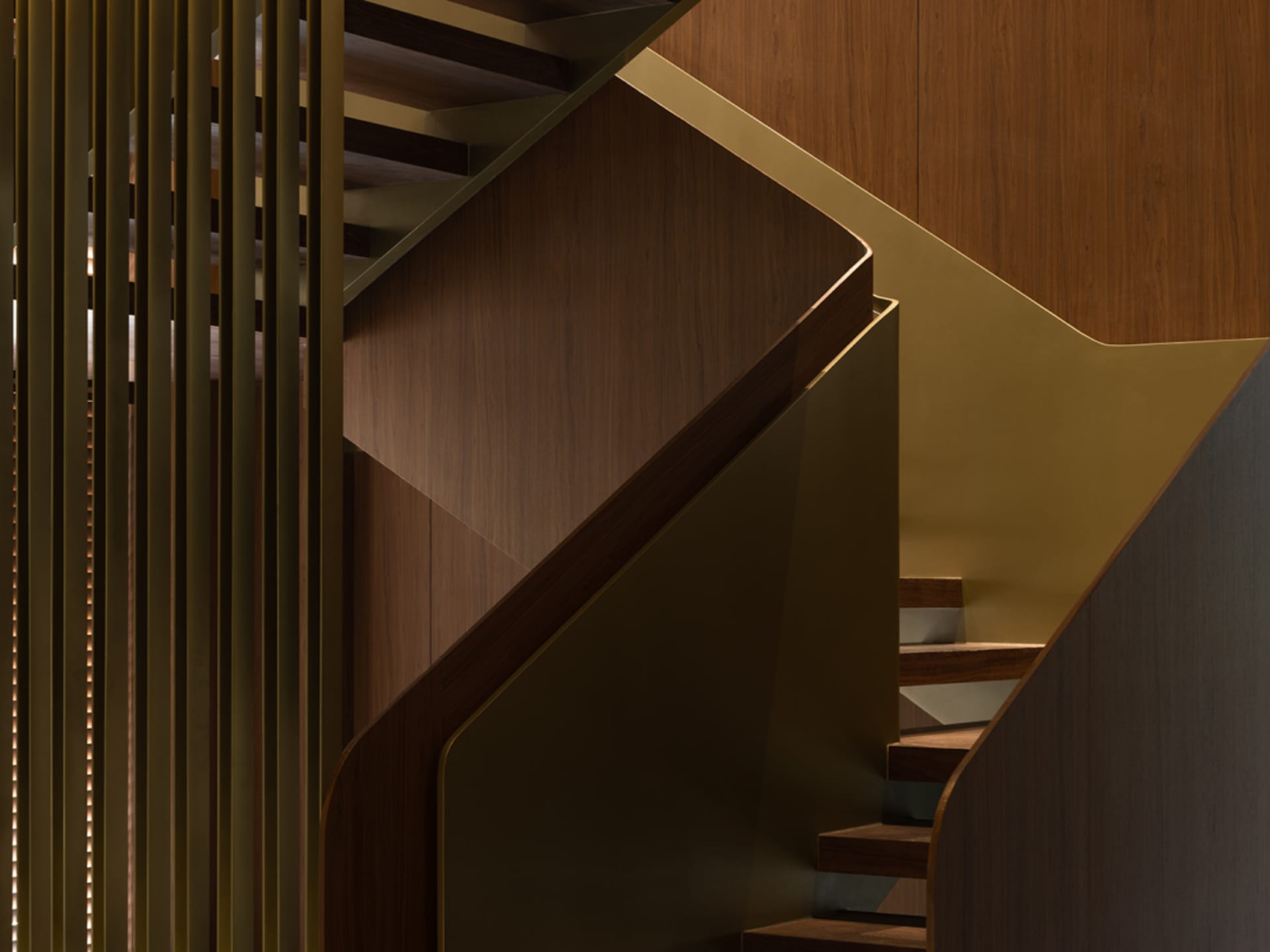 Staircase with modern design featuring wooden steps and railings.