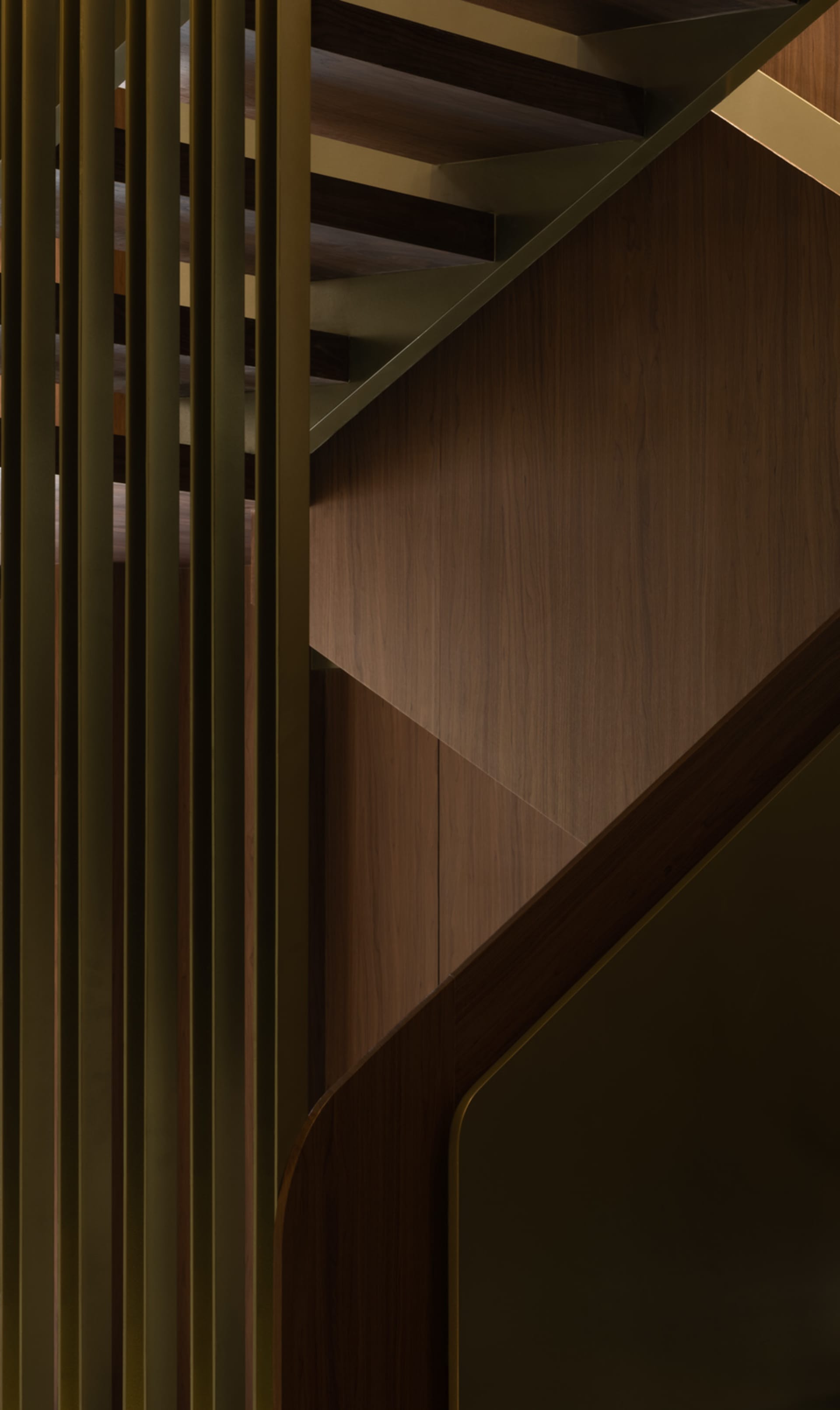 A modern staircase featuring wooden paneling, photographed in a detailed and close-up view.