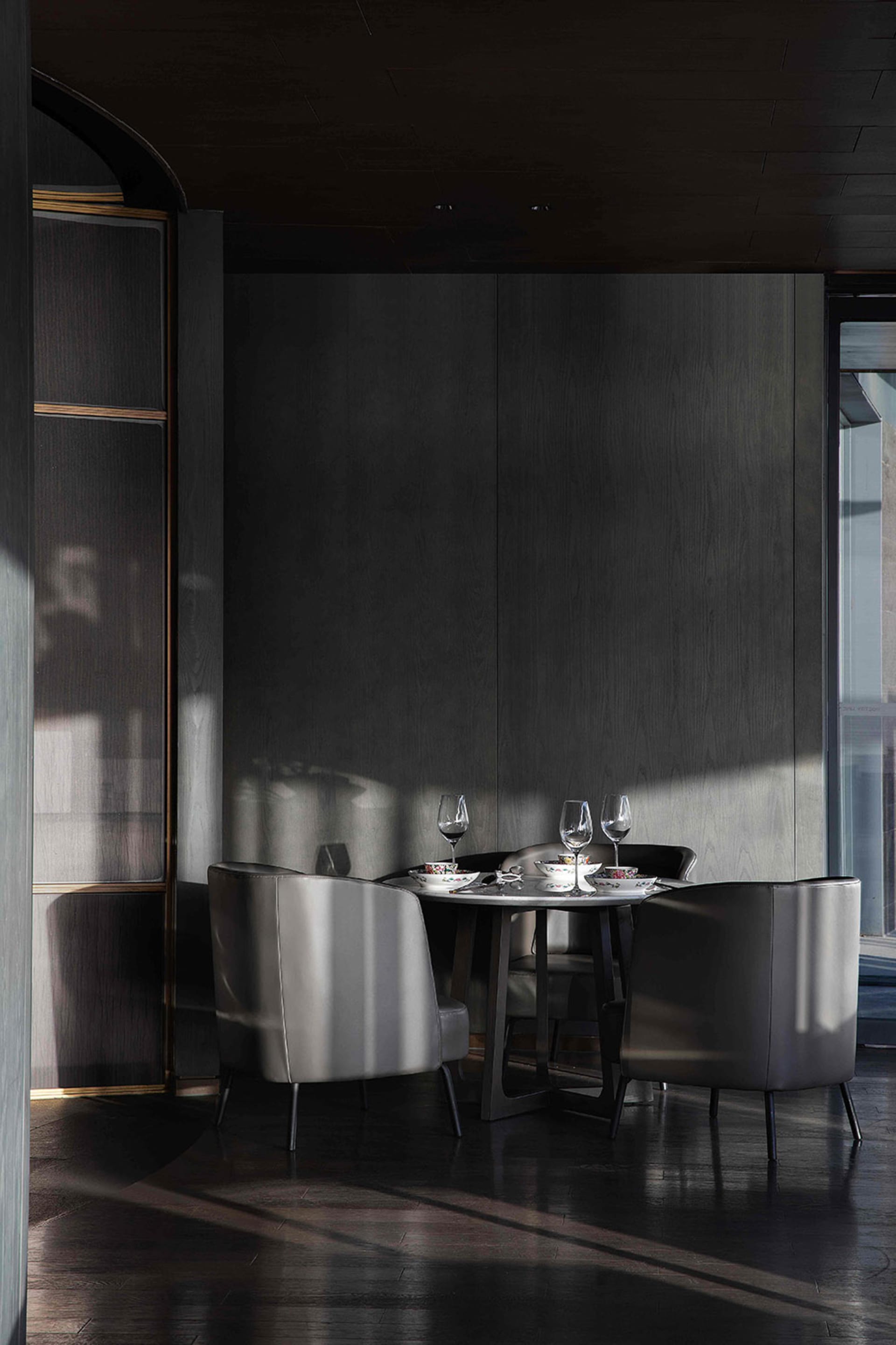 Modern dining room featuring metal chairs, leather seating, and wooden accents.