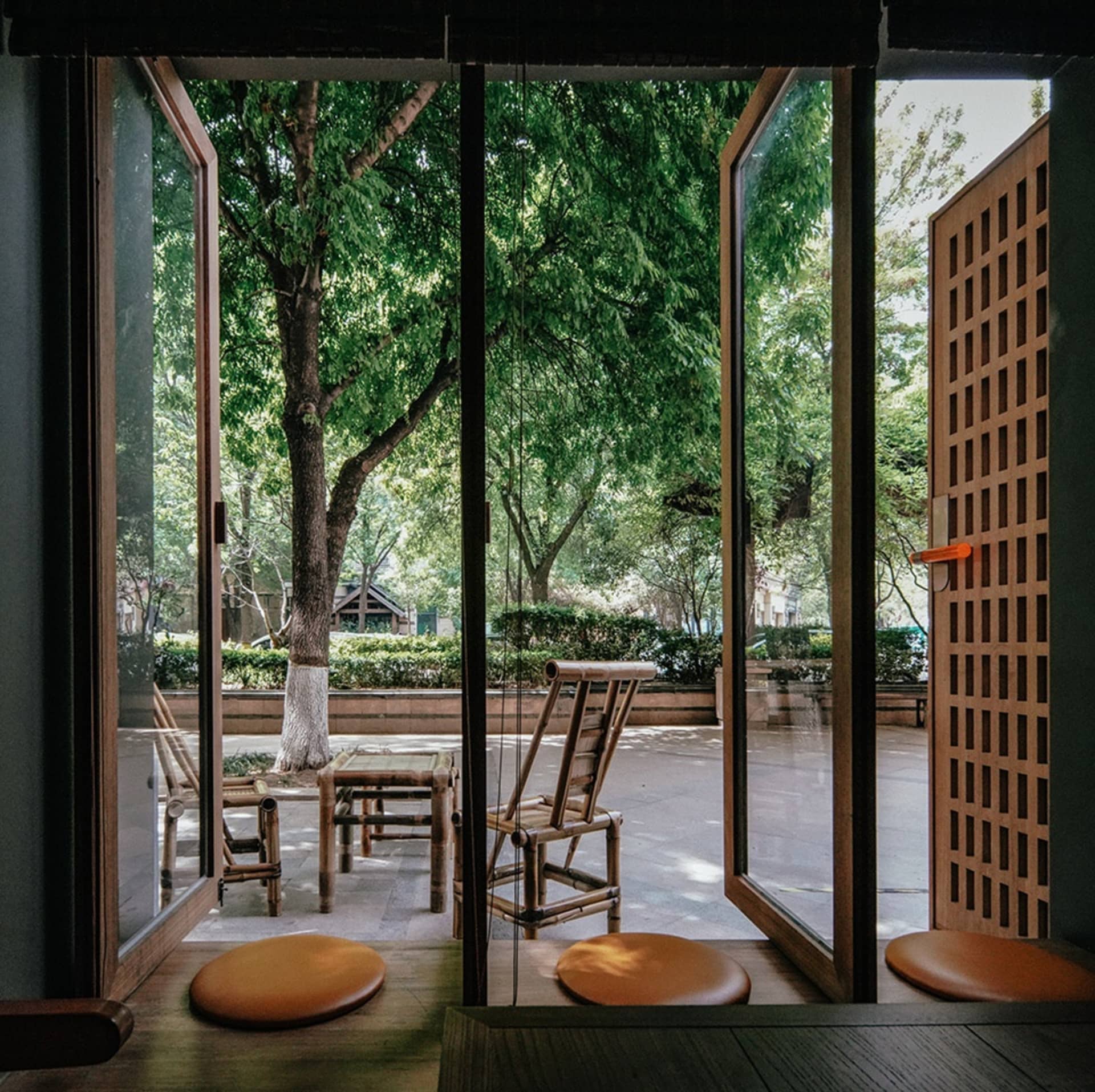 A view of a coffee shop featuring bamboo furniture and seating.