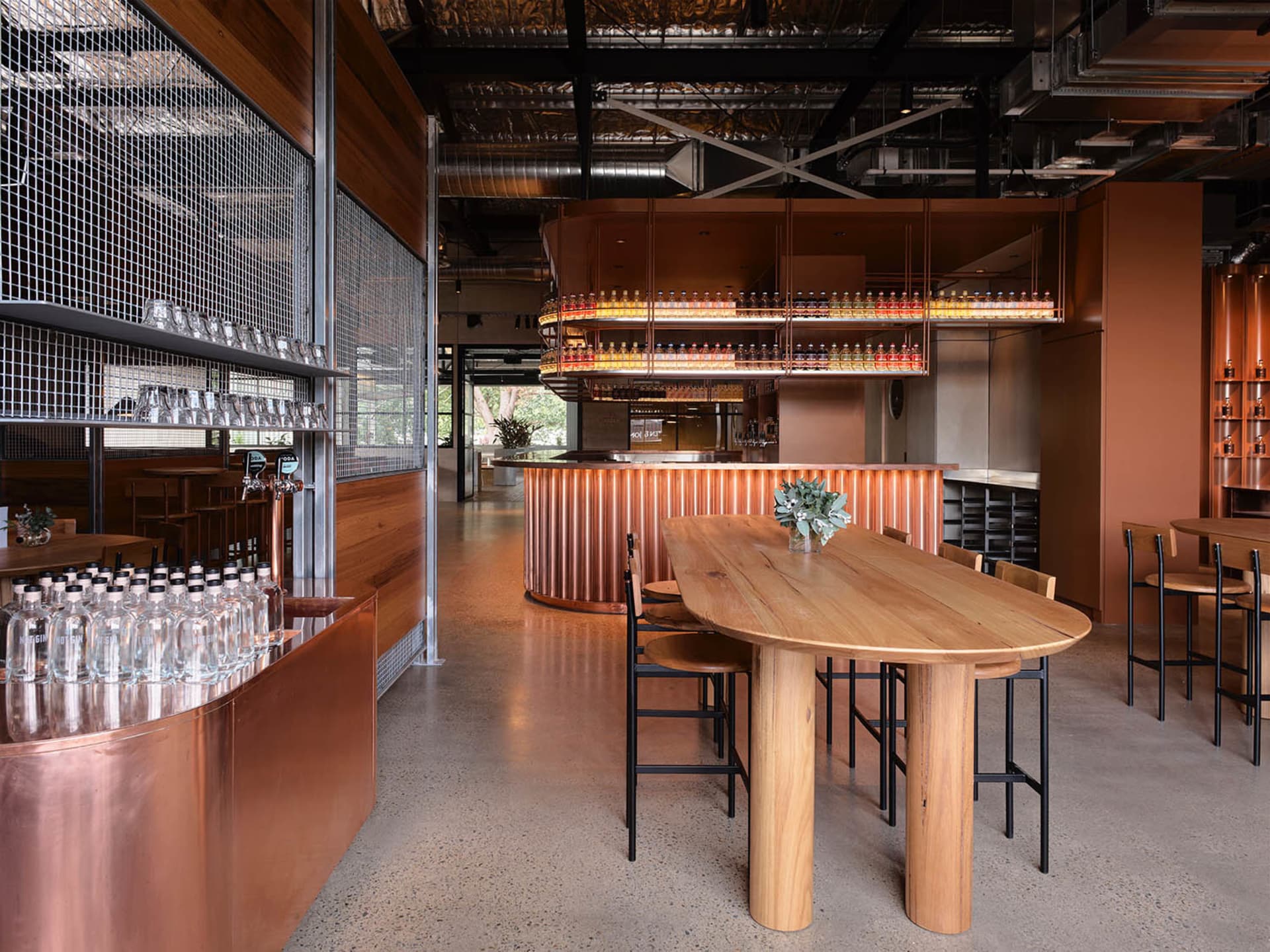 Modern bar with wood, copper, and concrete materials