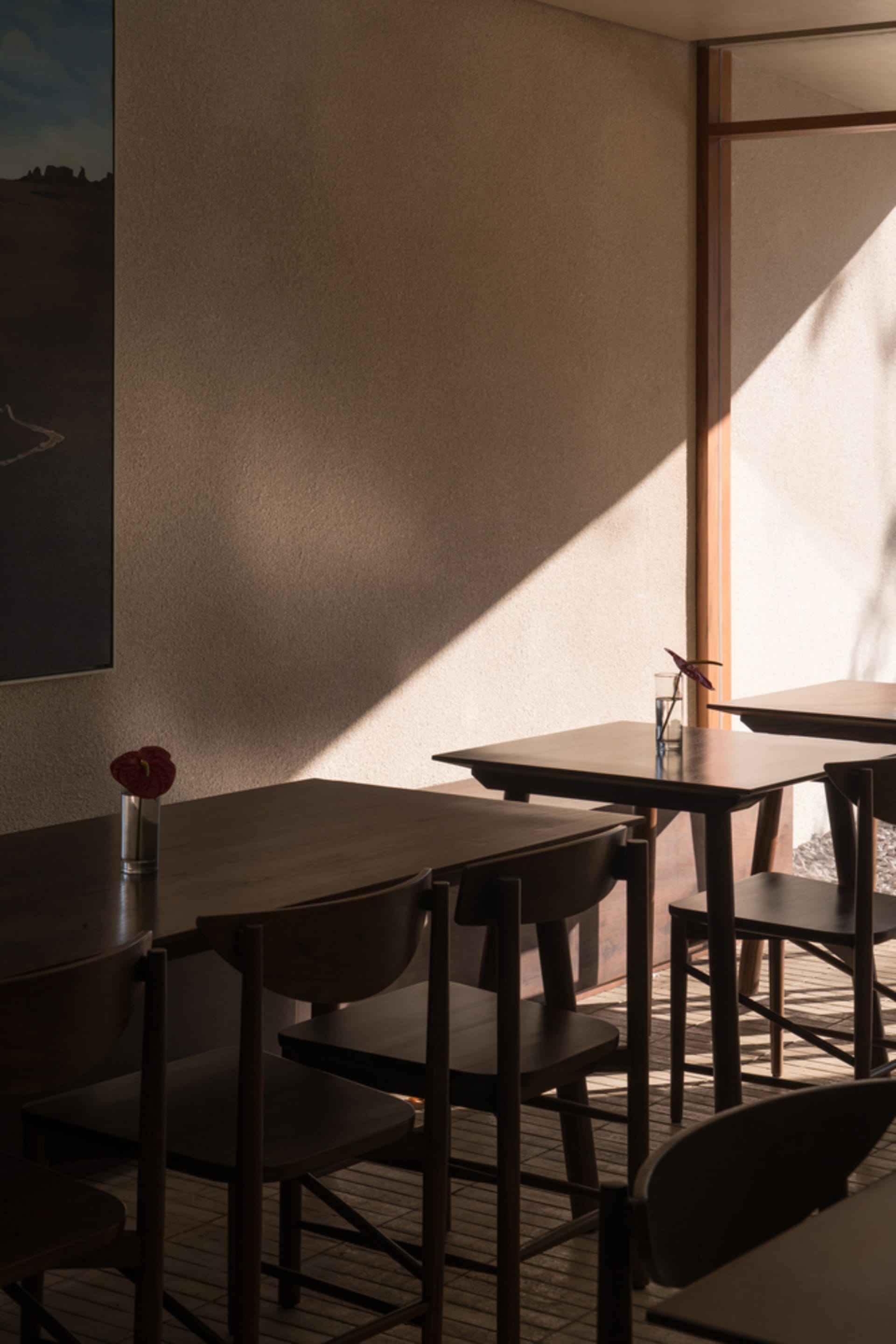 Modern restaurant interior with wooden furniture and minimalist design.