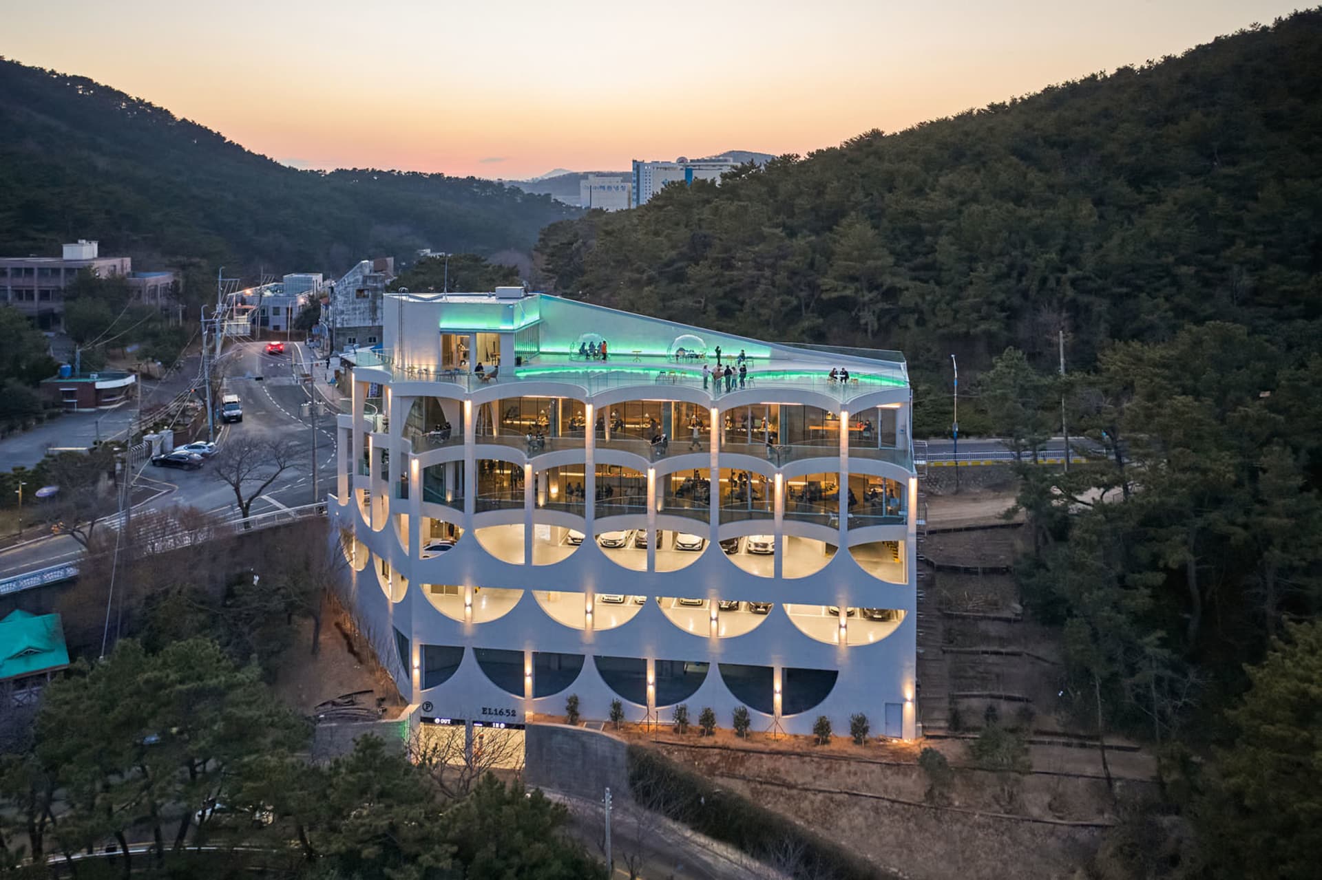 A modern office building with large glass windows and a concrete exterior.
