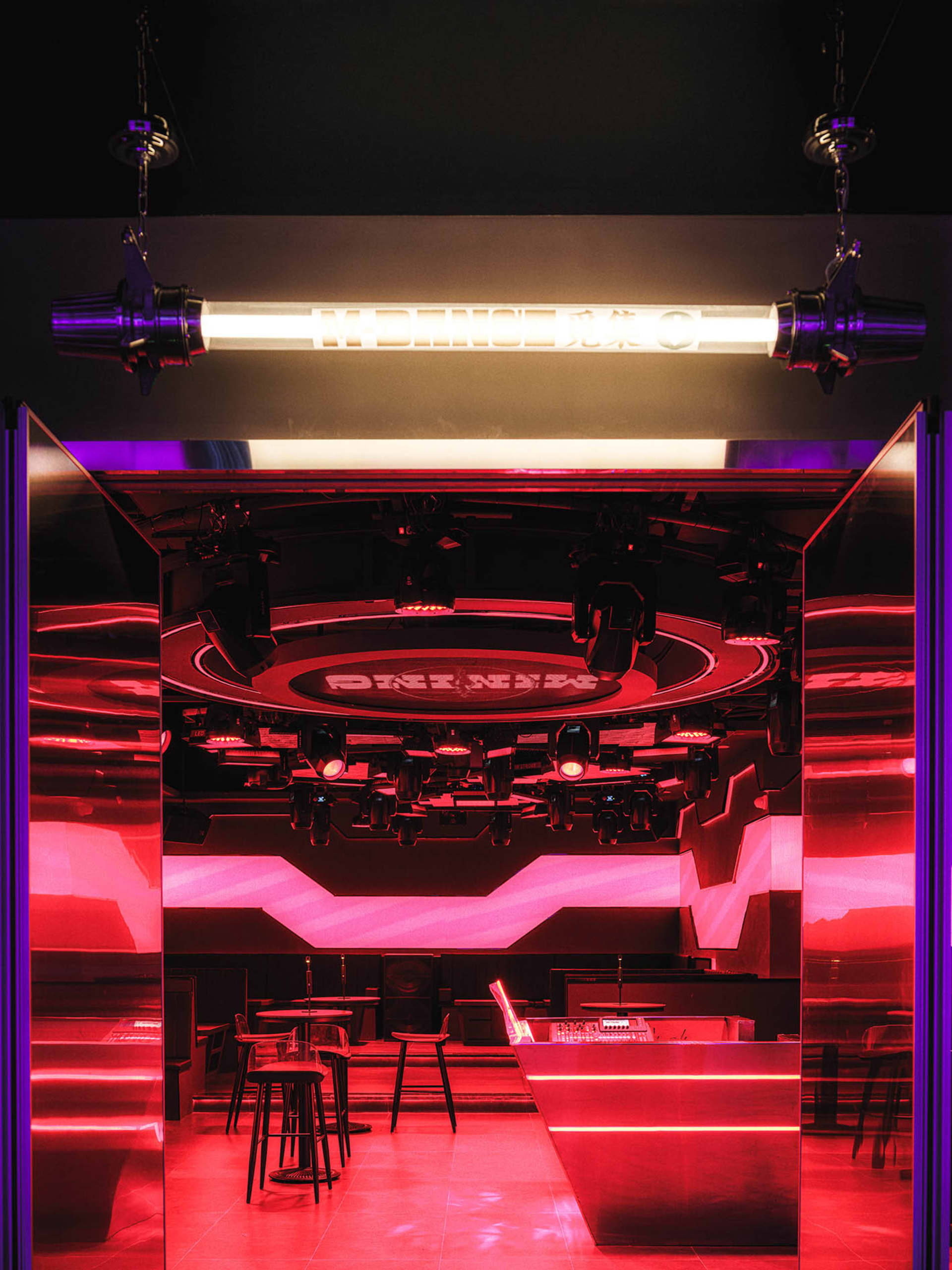 A brightly lit dance floor with metallic elements and red lighting.