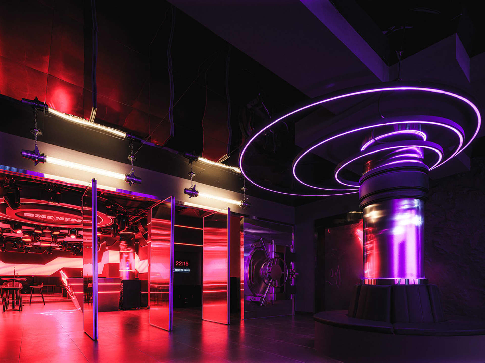 A vibrant nightclub interior with metallic elements and neon lighting.