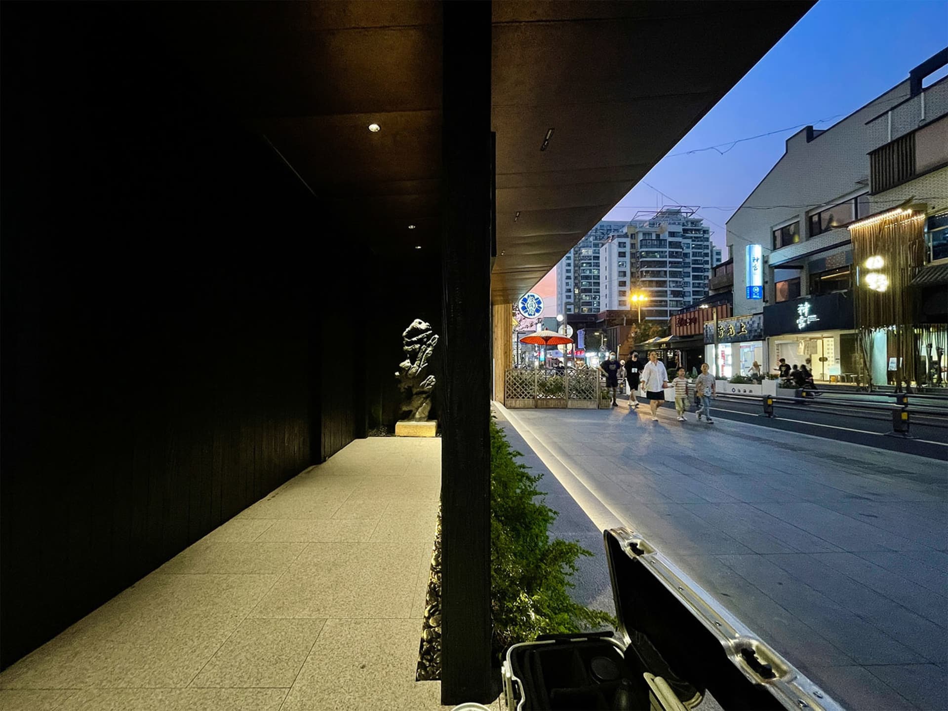 A bustling urban streetscape featuring concrete sidewalks and asphalt roads.
