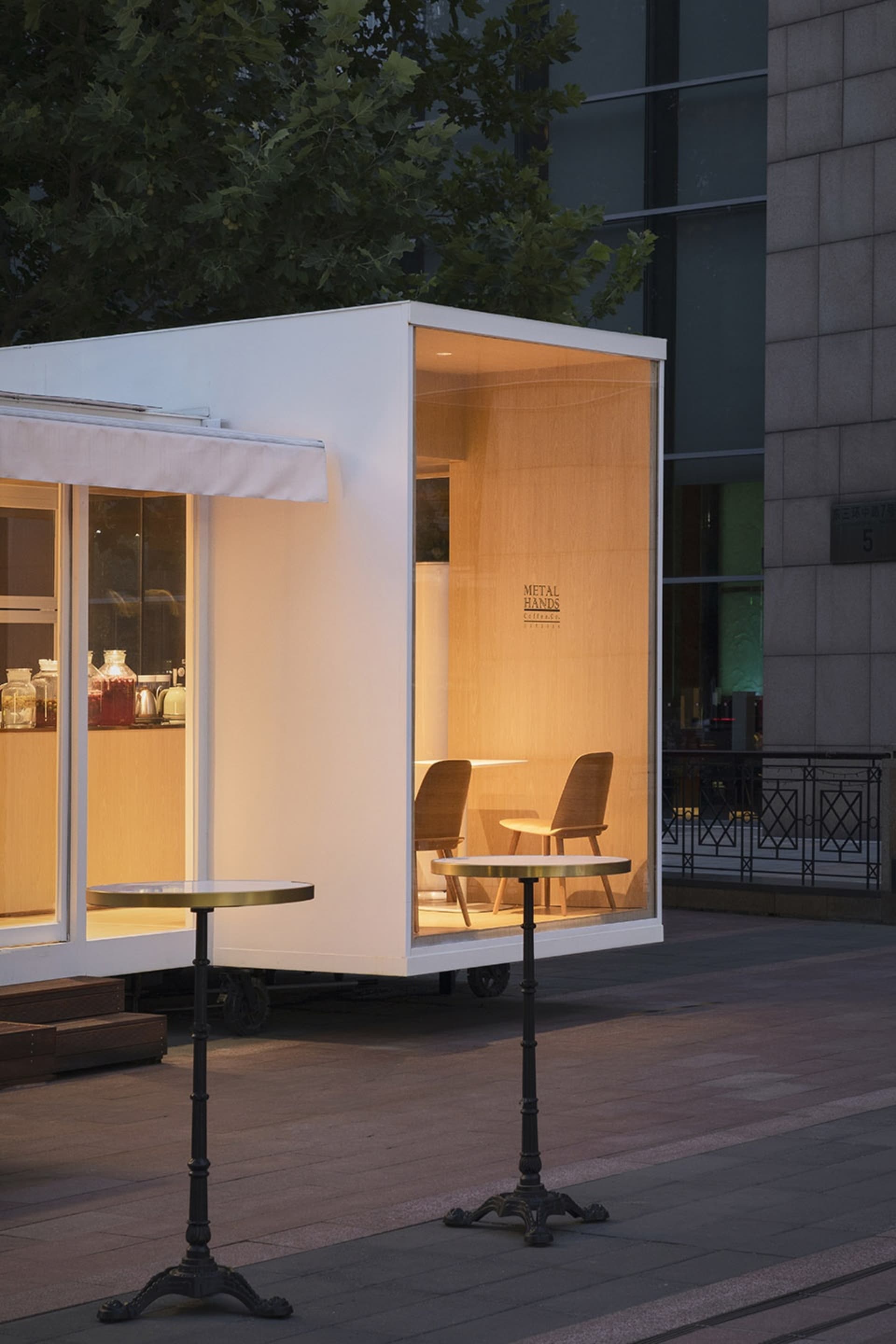 Modern furniture cafe exterior made of wood, steel, and glass.