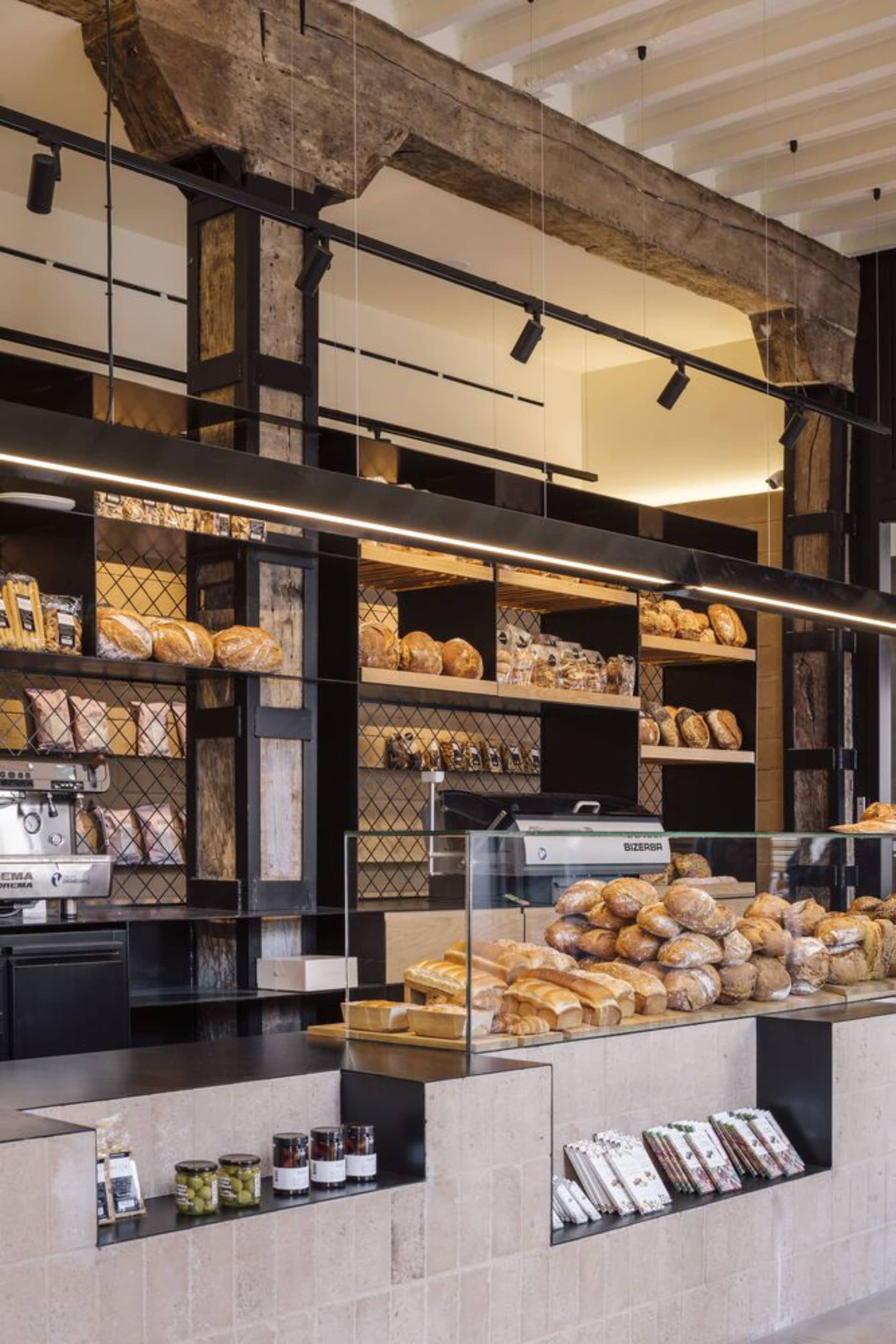 A bakery interior showcasing a mix of wood, metal, and concrete materials.