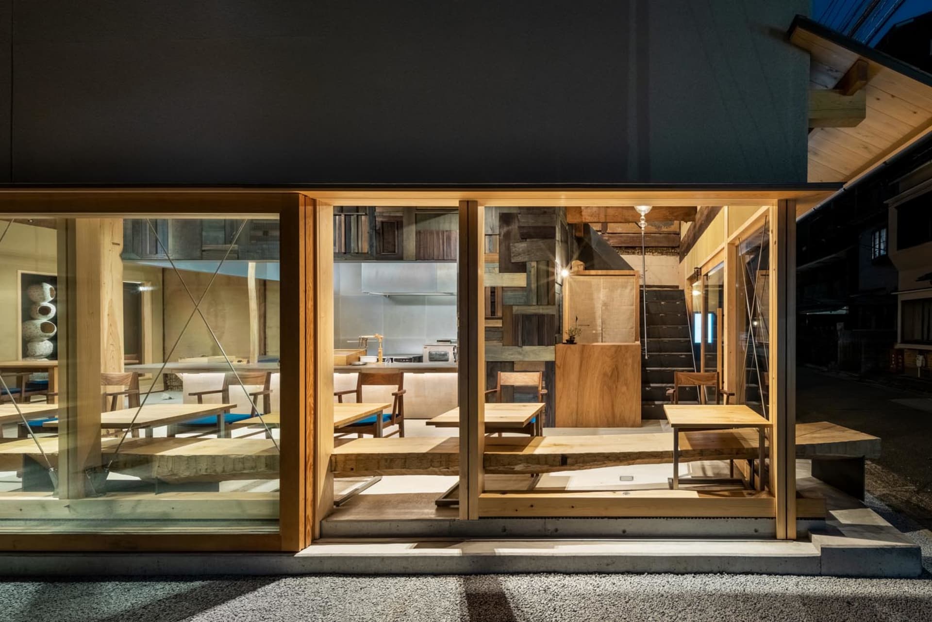 Modern, industrial-style restaurant interior featuring wooden tables and chairs.