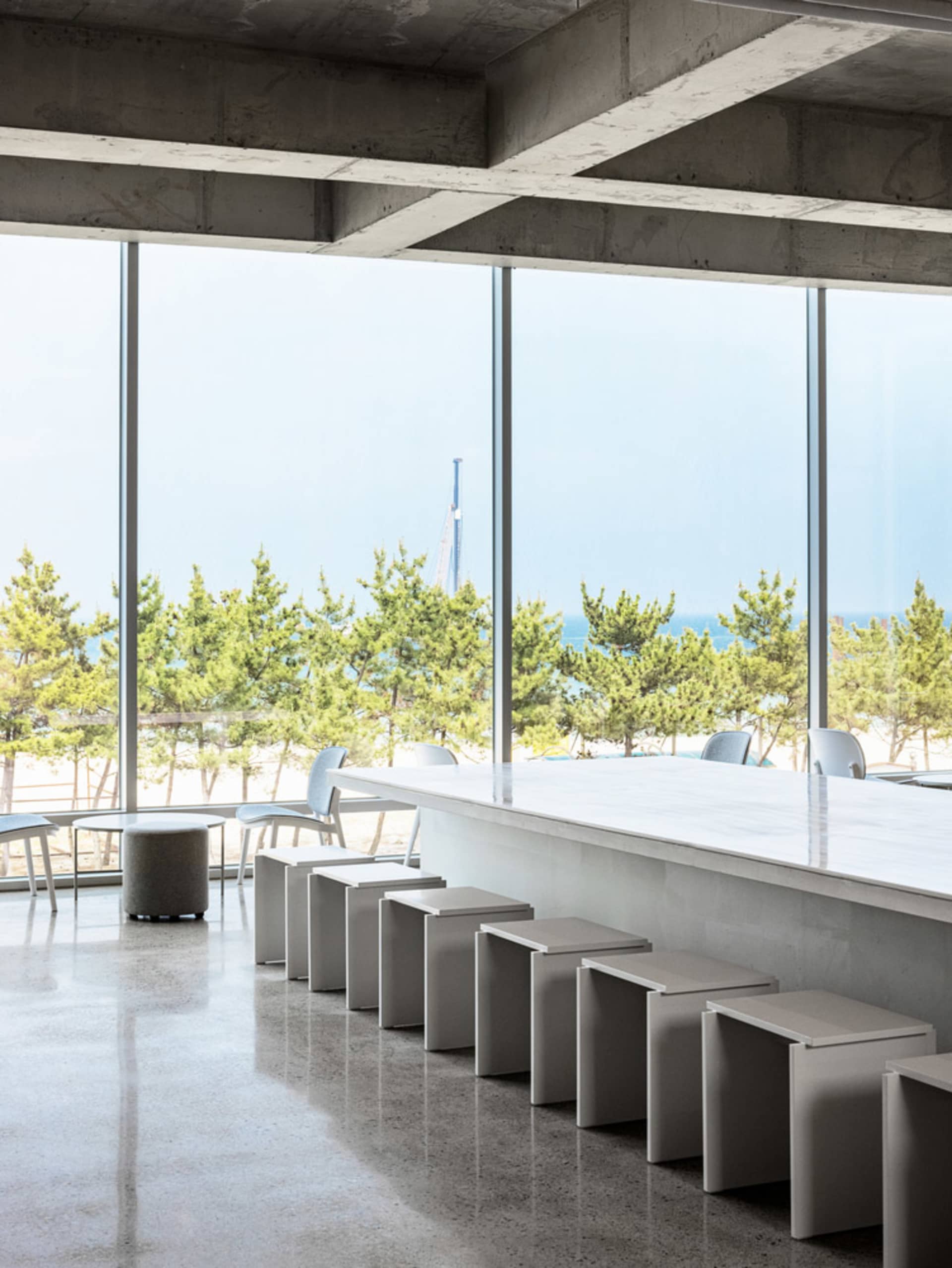 Industrial interior with concrete floors and stools.
