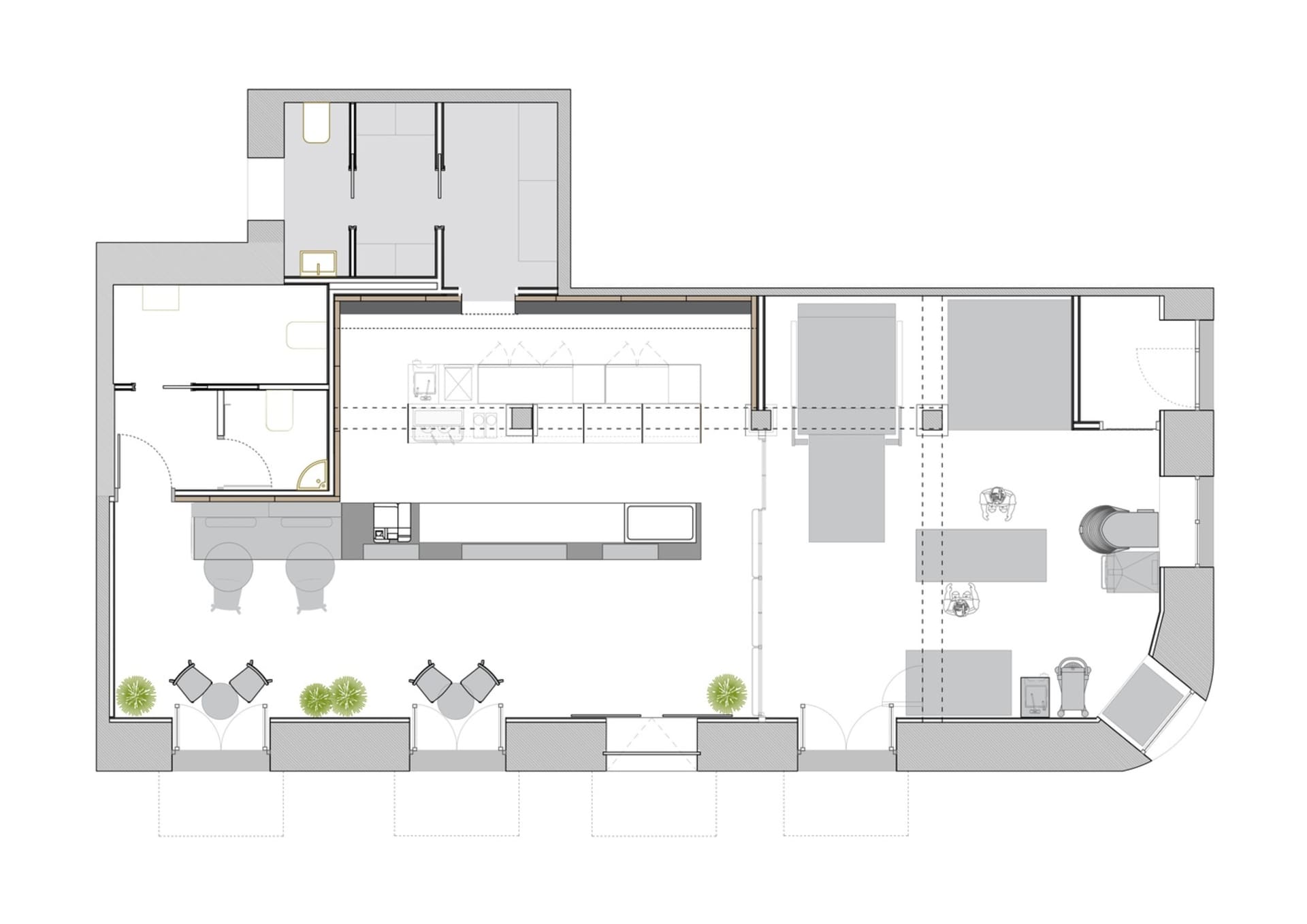 An industrial office space with workstations and a kitchen area.
