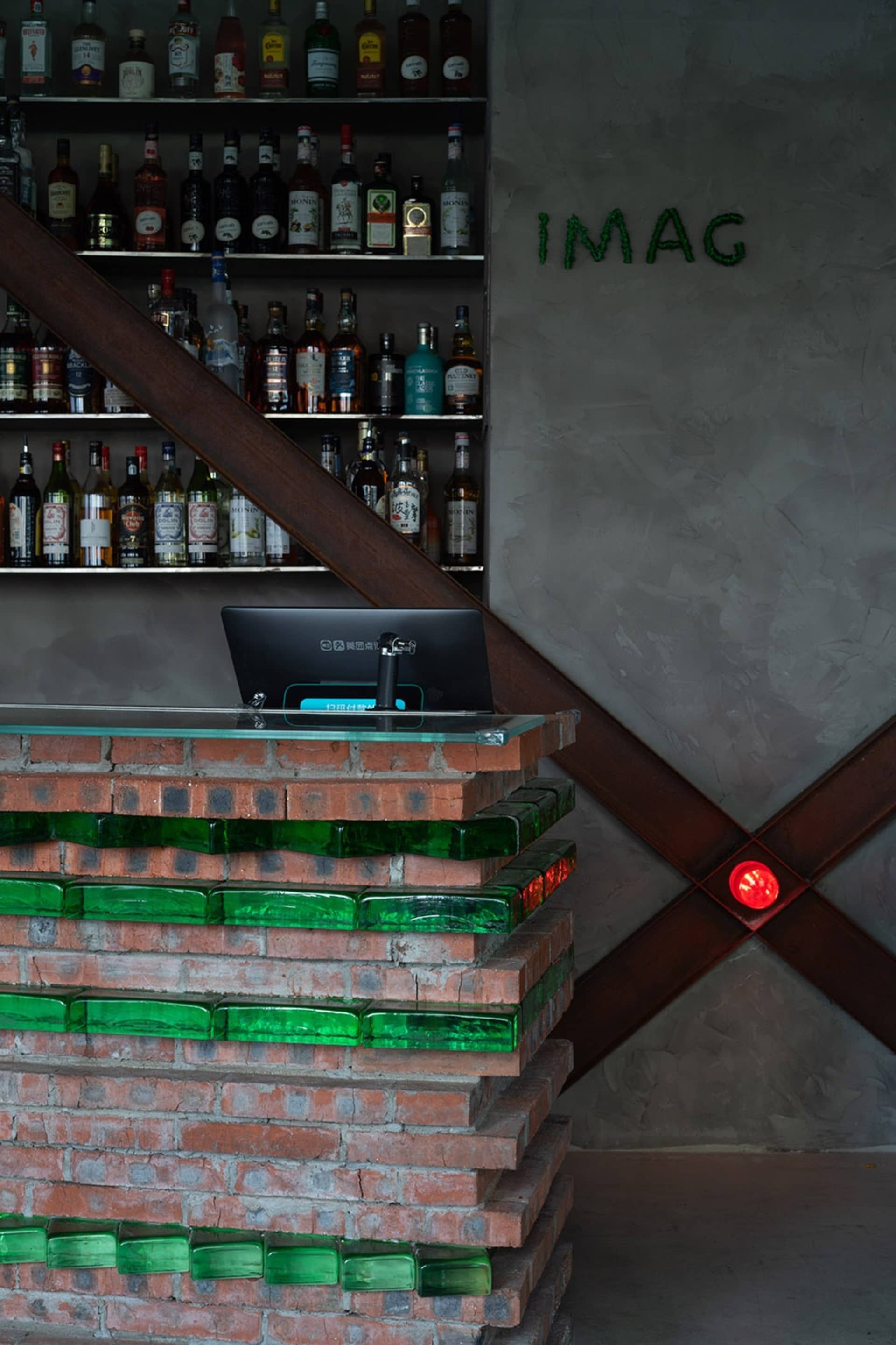 Photo of an industrial bar featuring brick and glass materials.
