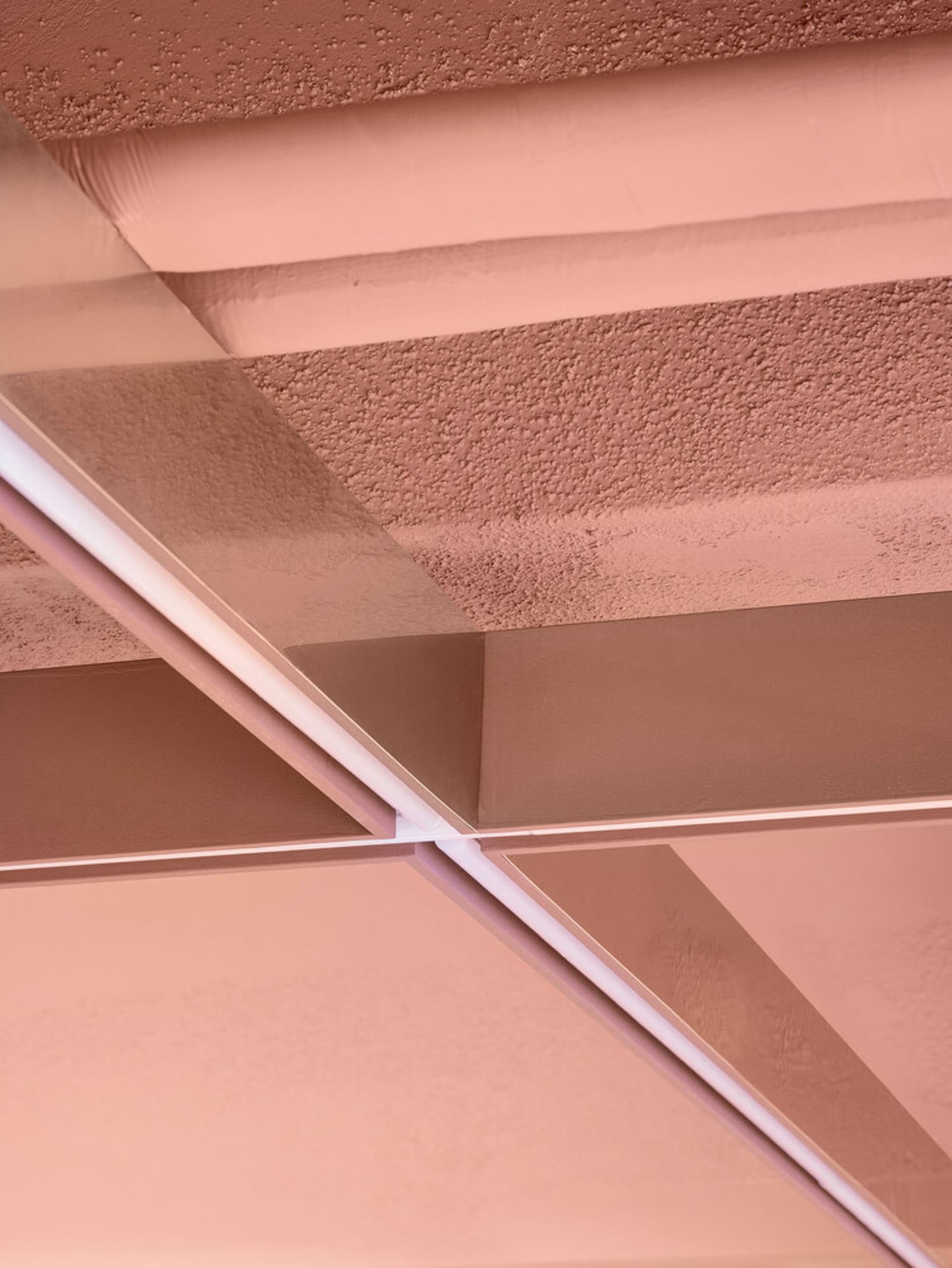 A minimalist interior design featuring metallic slat elements.