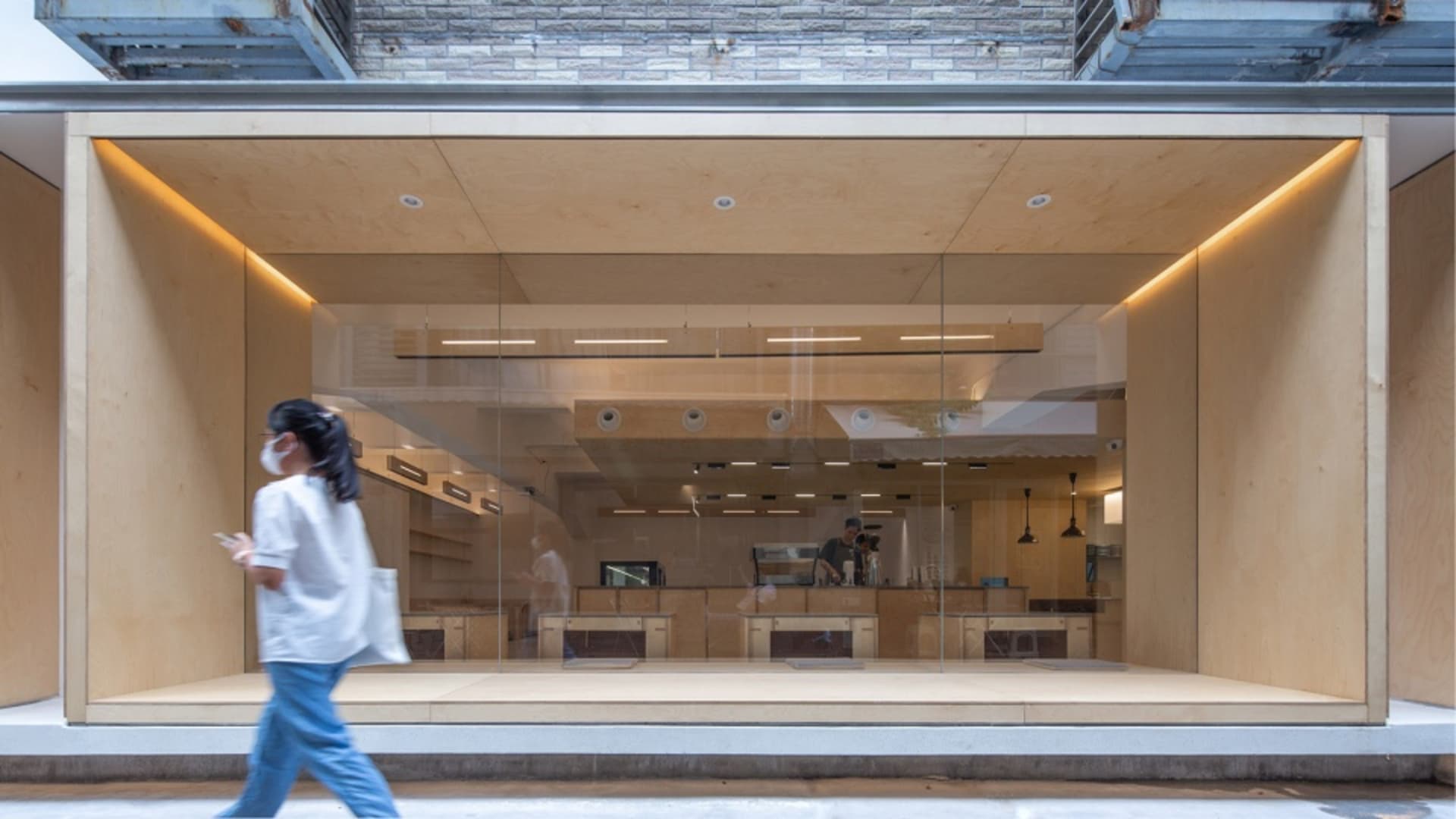 A modern cafe interior with wooden and glass elements.