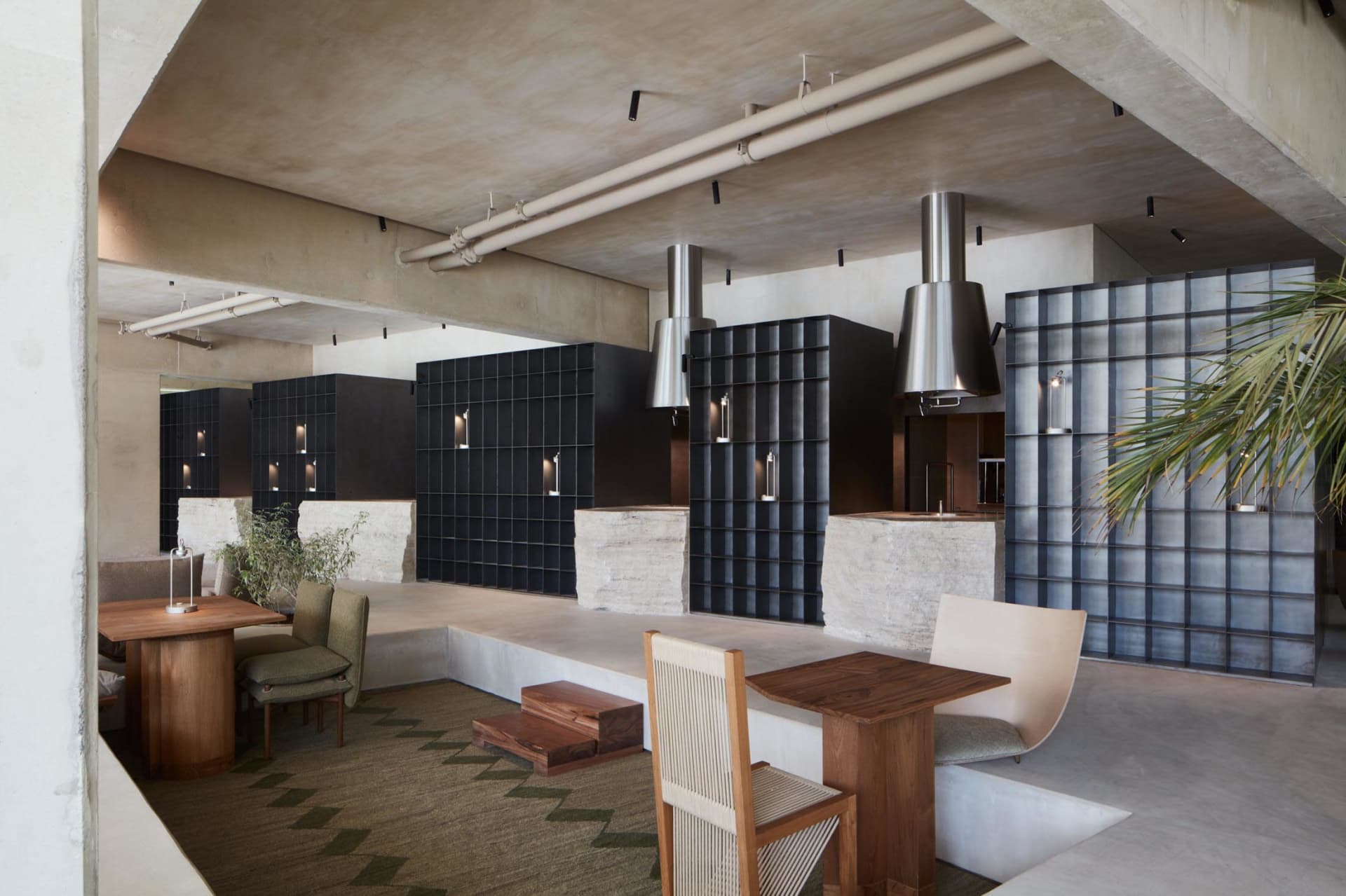 Industrial-style restaurant interior with concrete flooring and minimalist decor.