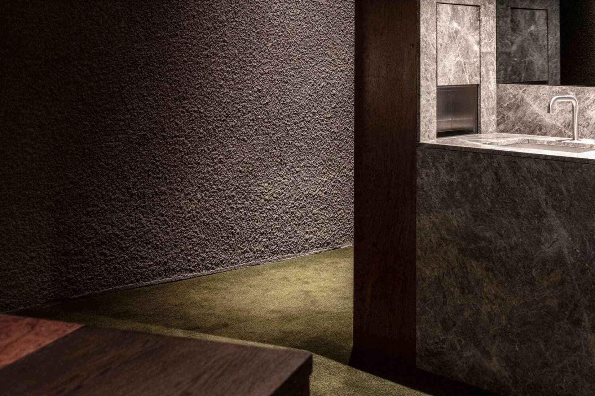 A minimalist mid-century interior featuring marble materials.