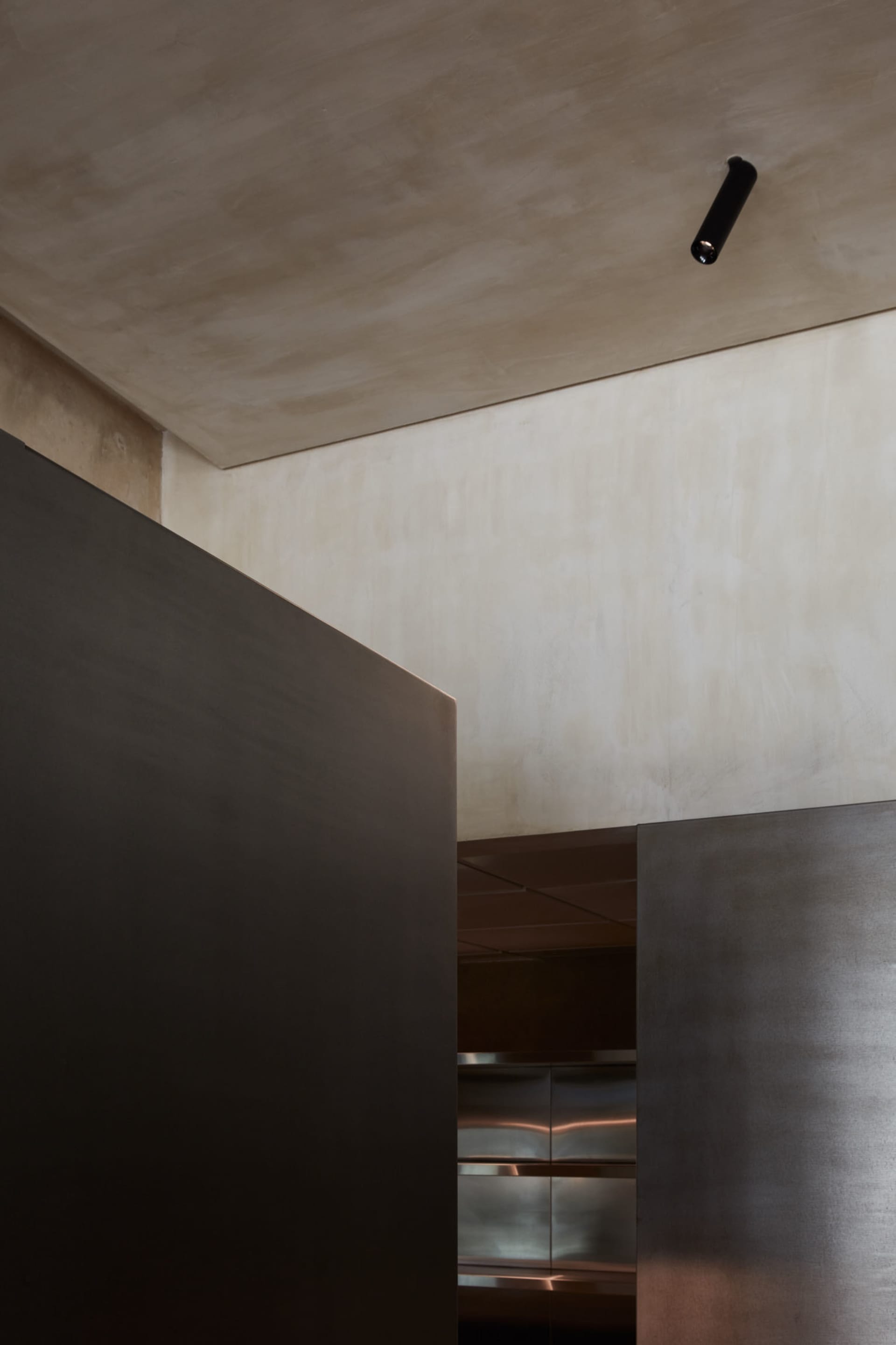 A modern industrial office space with metallic columns and concrete surfaces.