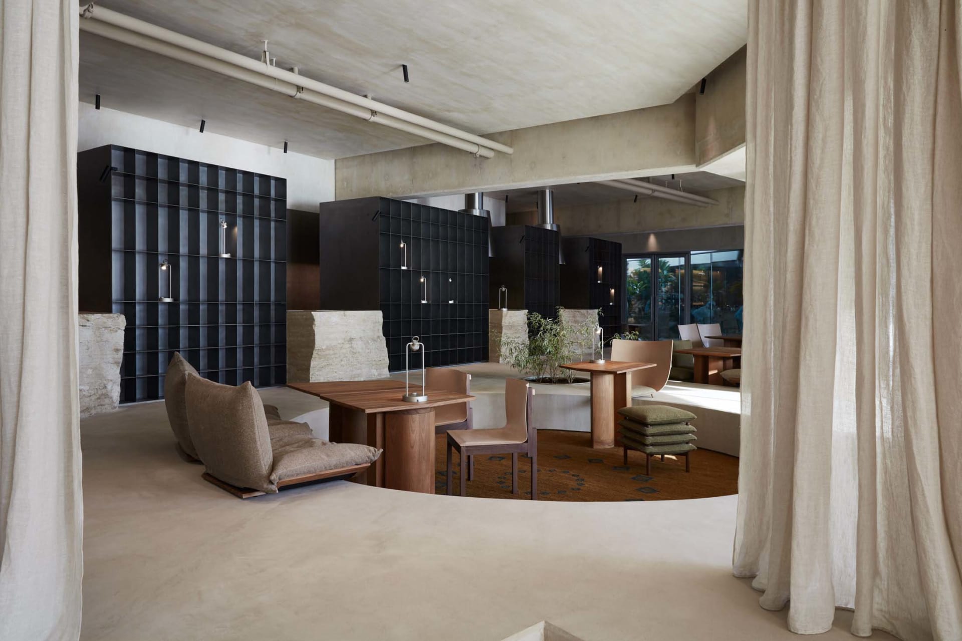 Modern restaurant interior with concrete and wooden elements.