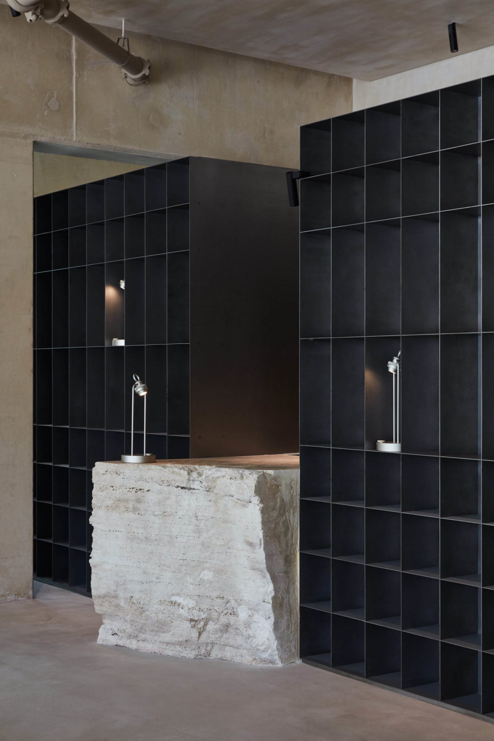 Industrial-style interior with concrete and black tiled surfaces