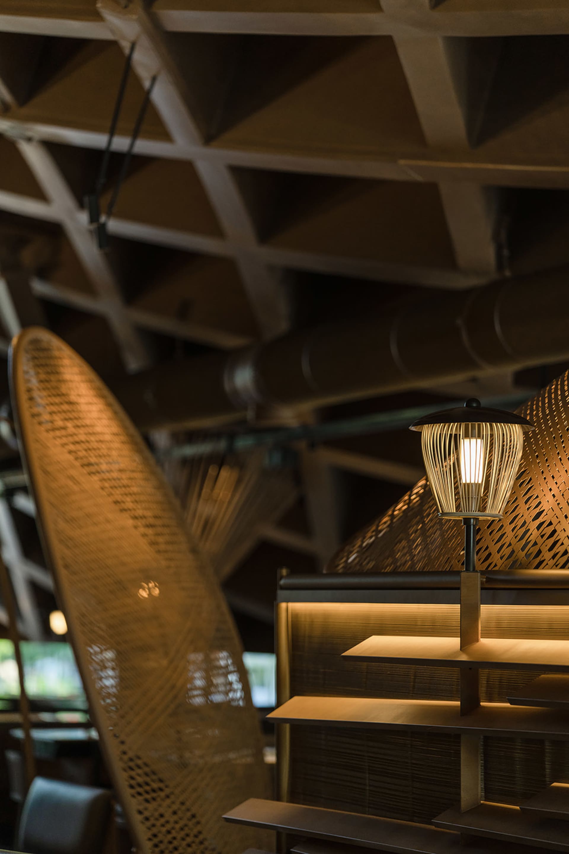 Modern industrial restaurant interior featuring wood elements and lighting fixture