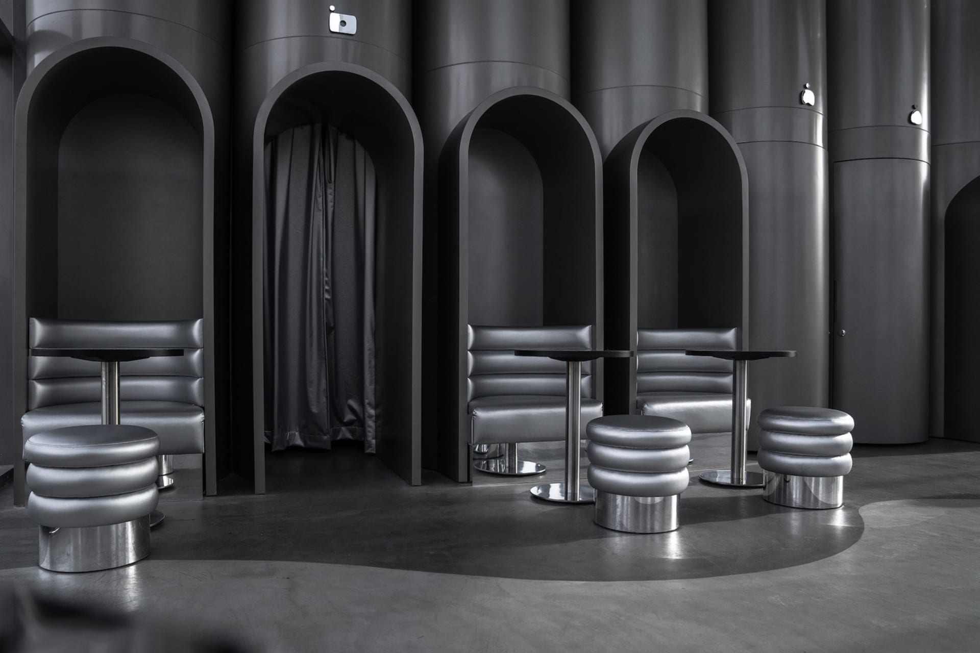 A modern industrial seating area with metallic furniture