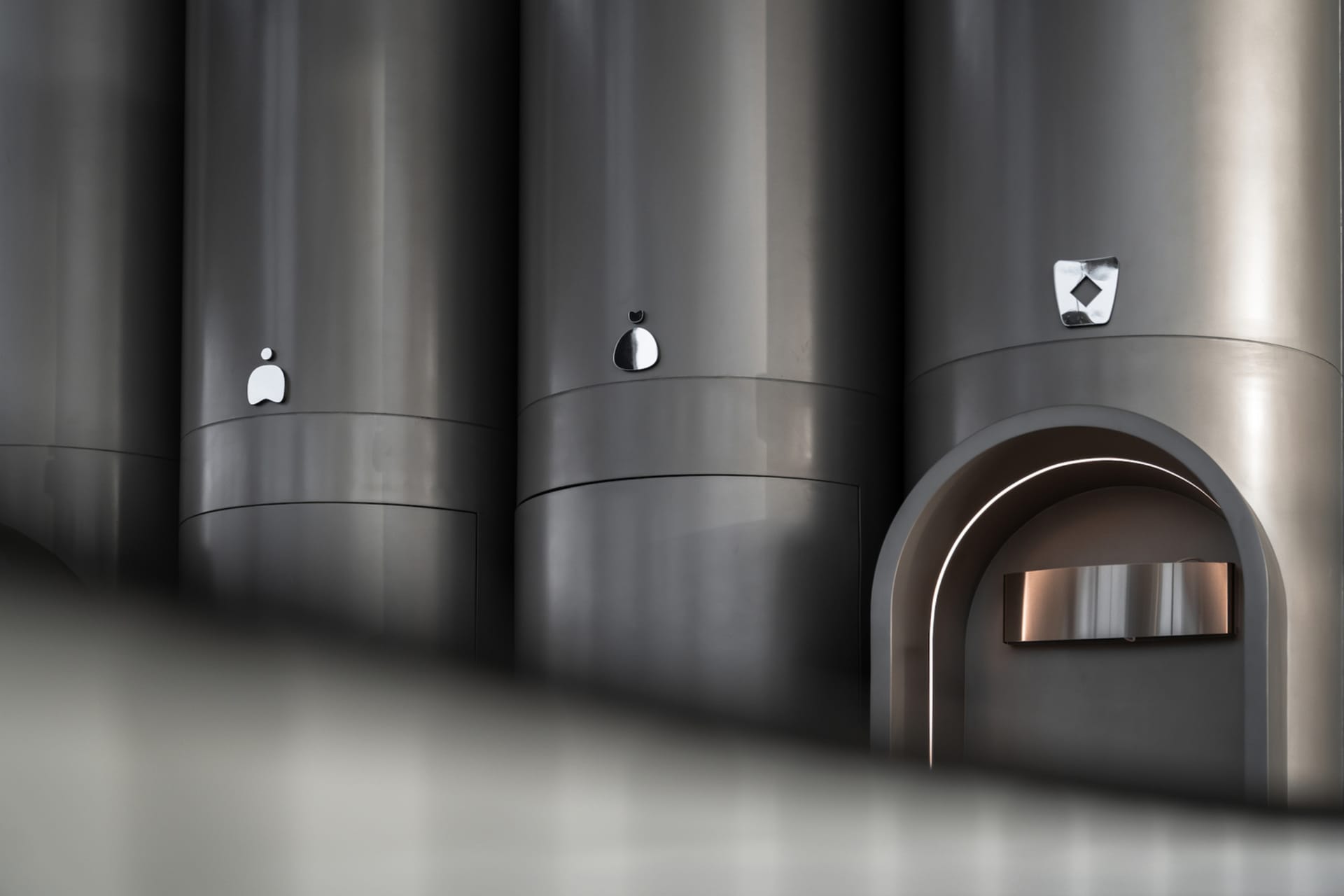 Modern, minimalist metal architectural elements featuring sleek, curved shapes and geometric designs.