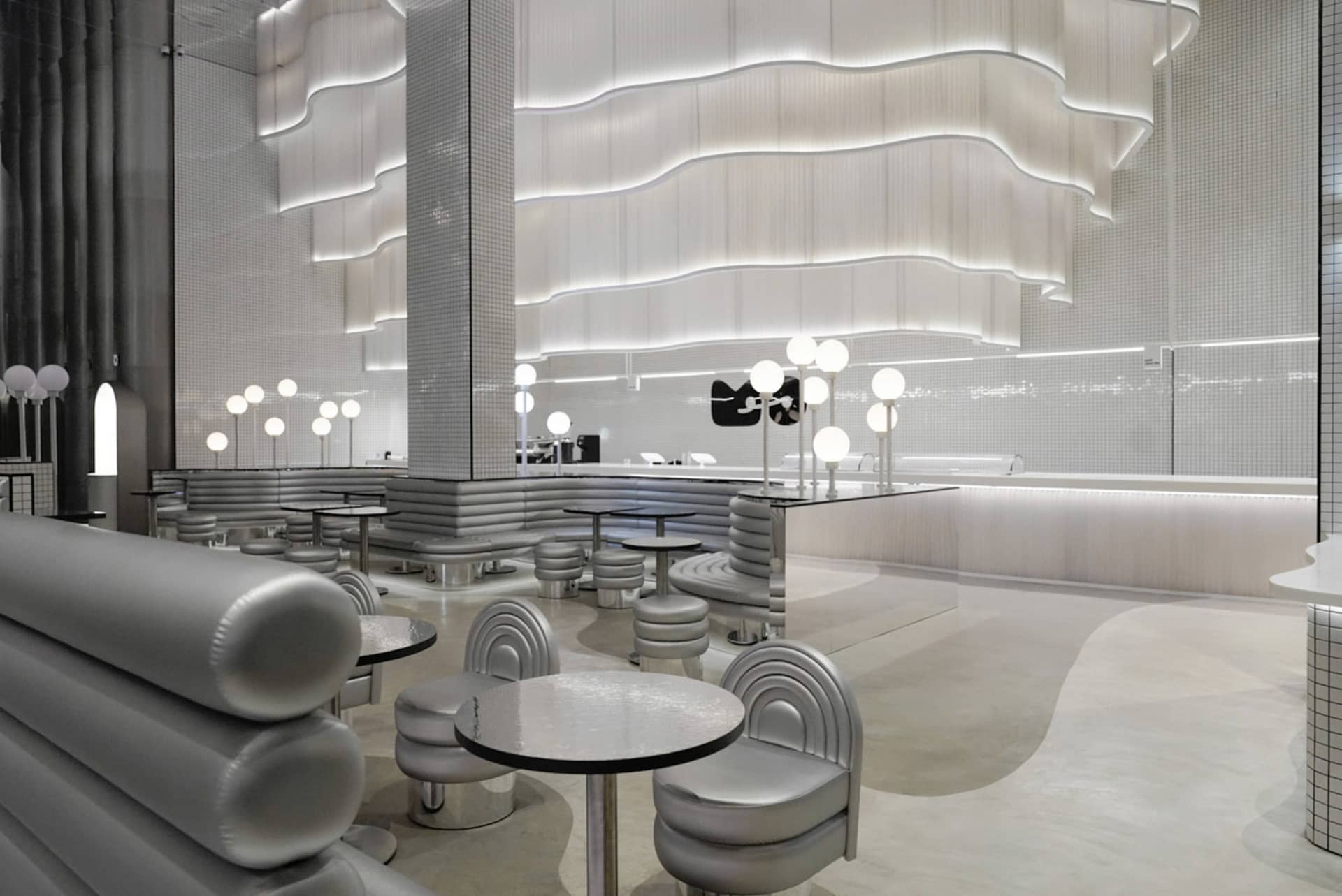A modern minimalist restaurant featuring contemporary design elements and futuristic lighting.