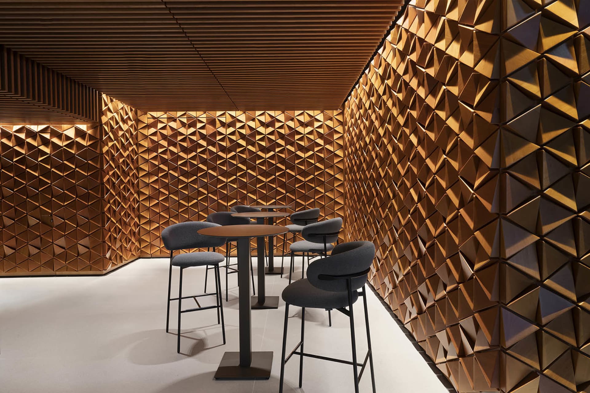 Modern restaurant interior with wooden decor and high-top seating