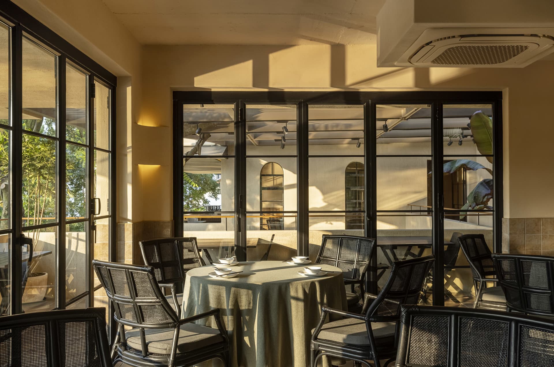 An indoor cafe with metallic furniture and a minimalist design.