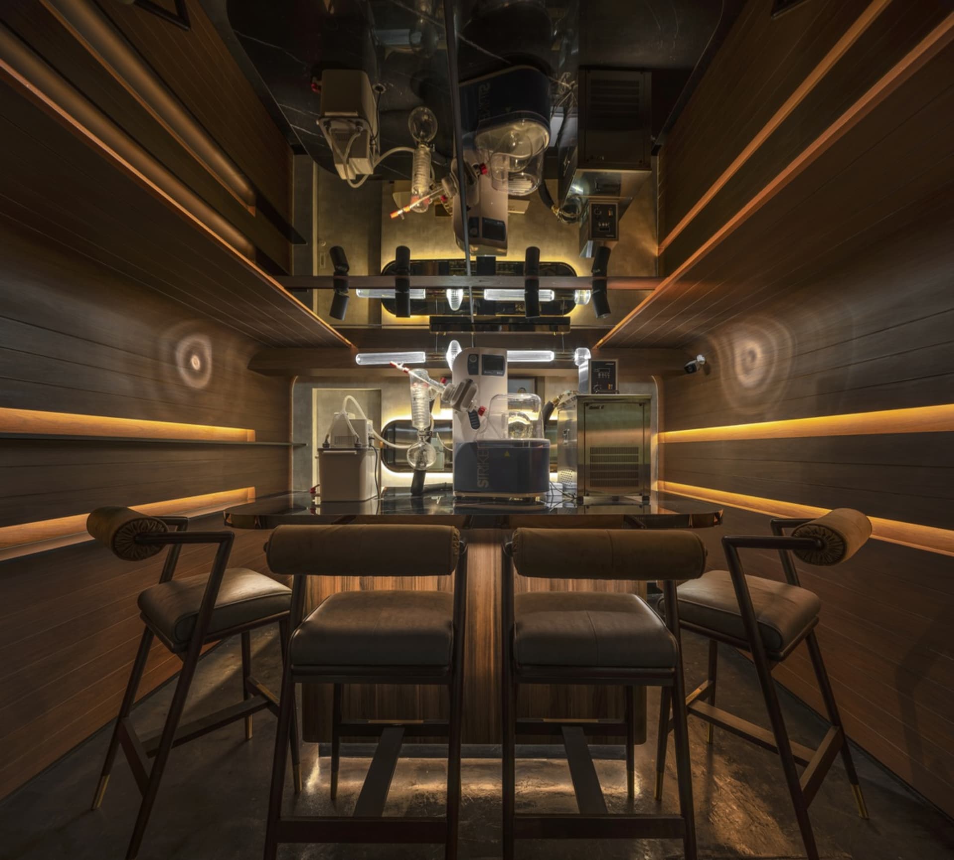 Industrial-style bar with metal stools, glass tubes, and industrial equipment.