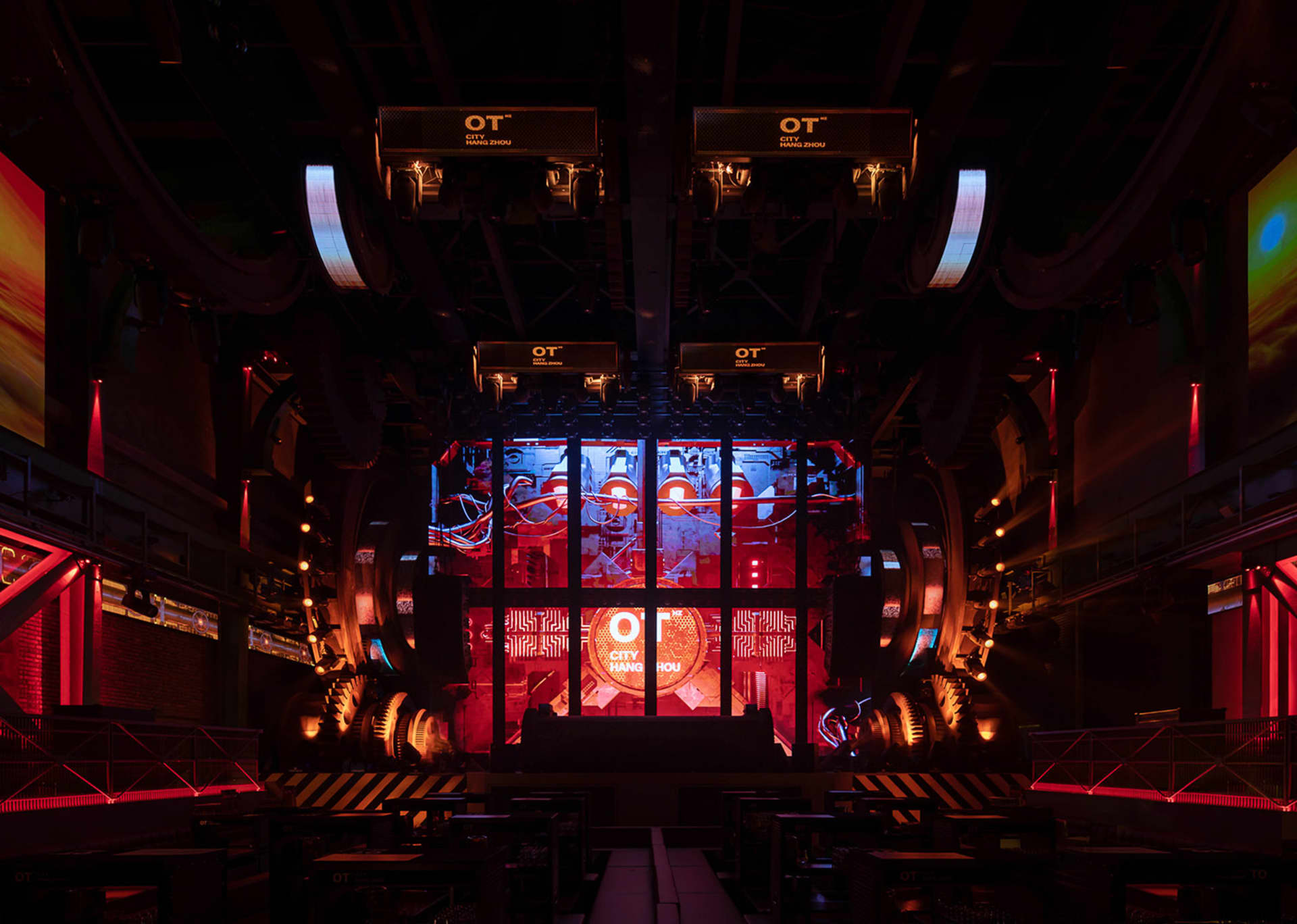 An industrial-style stage with metallic elements and lighting.