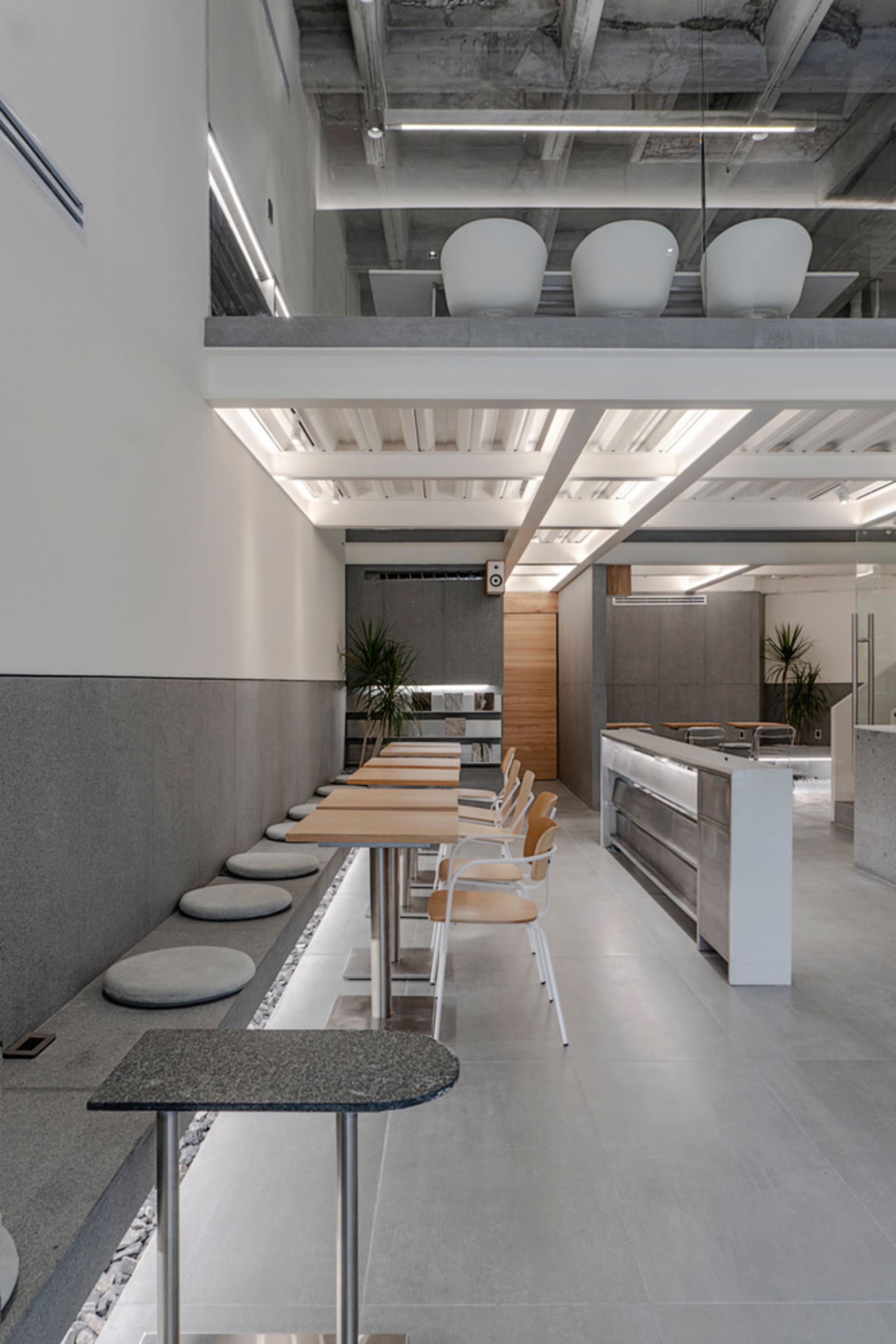 A modern coffee shop with concrete walls and minimalist design