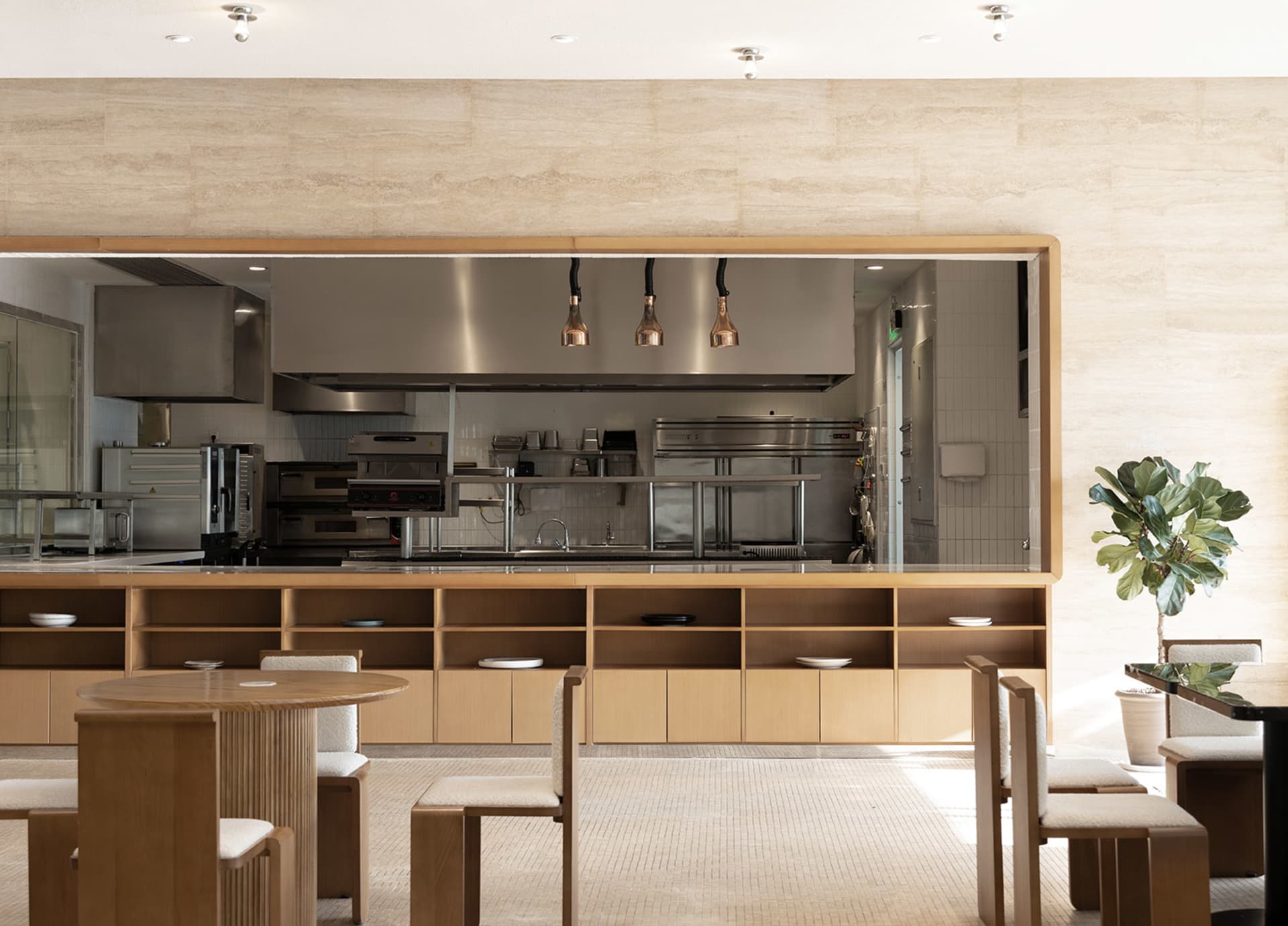 Industrial-style restaurant interior with copper pendant lights and wood furnishings.