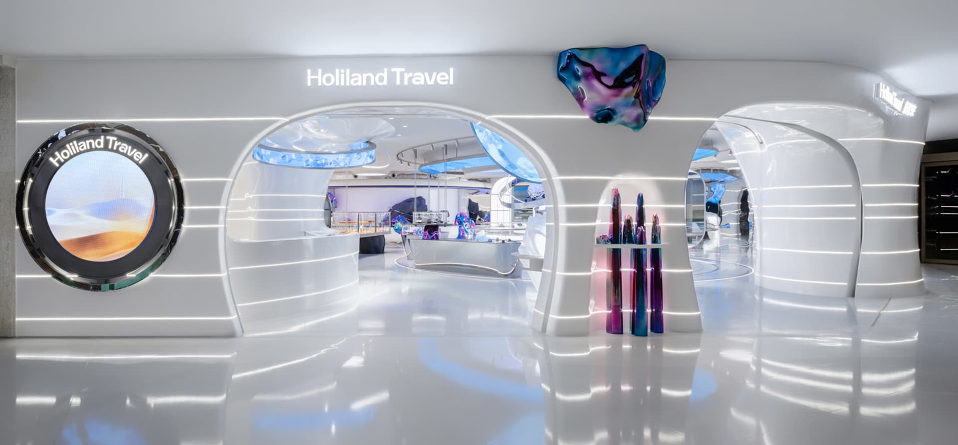 Interior of a minimalist travel agency with metallic and white design elements.