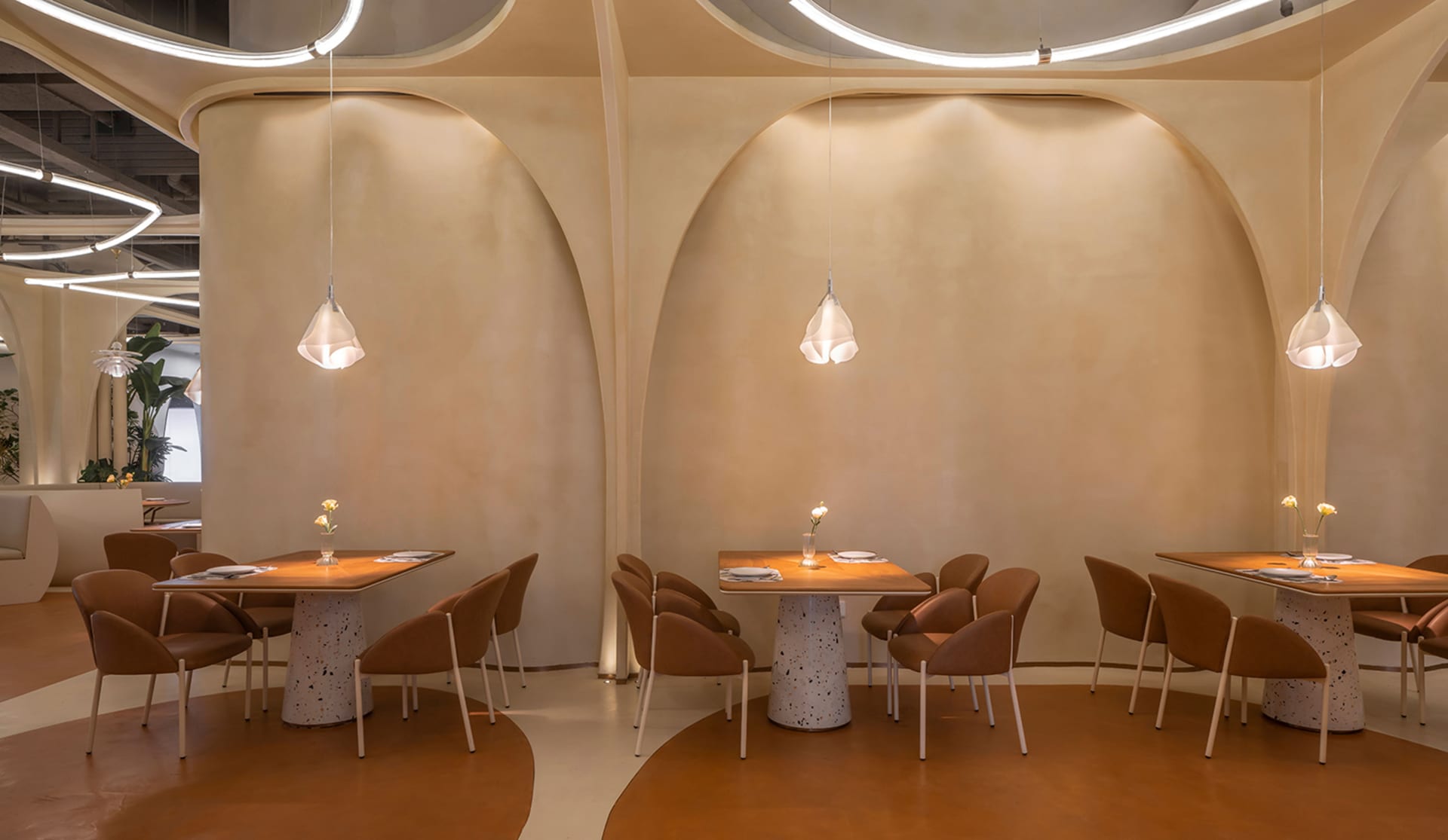 Modern restaurant dining area with terrazzo tables and chairs, minimalistic design style, curved archways, and minimal lighti