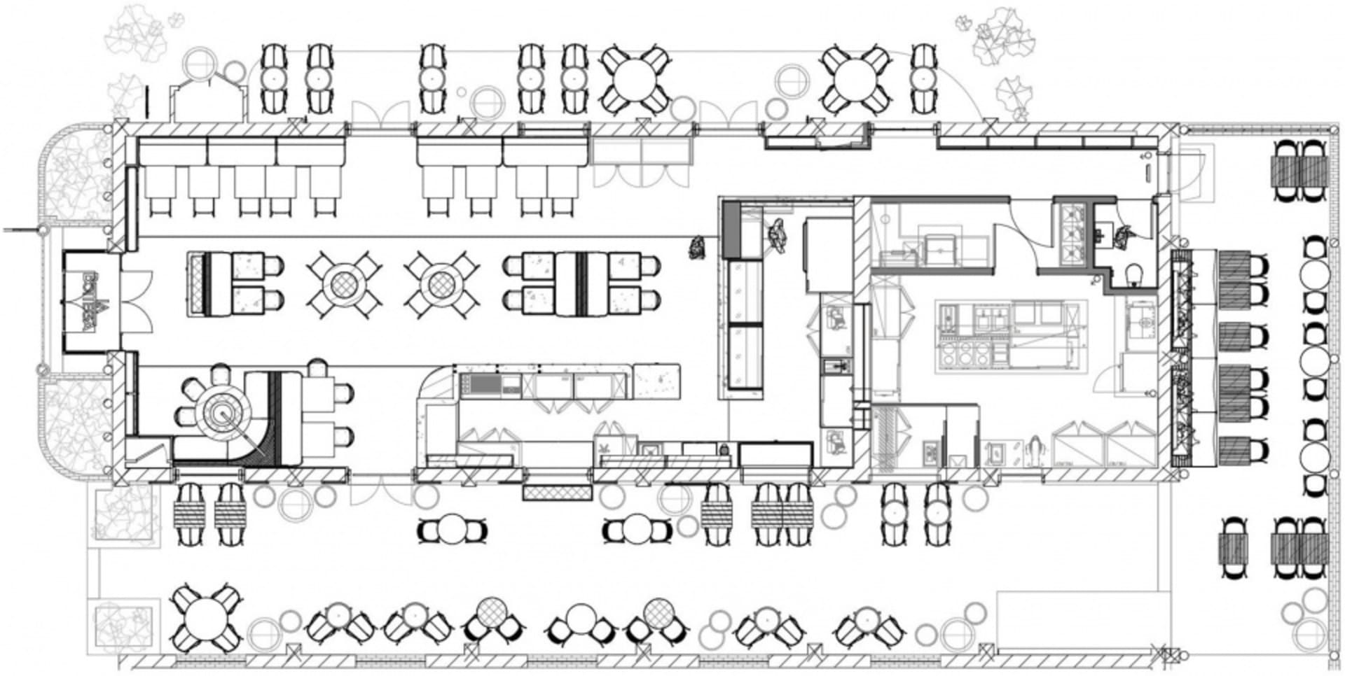 Industrial-style restaurant layout featuring open spaces, large windows, and natural stone finishes.