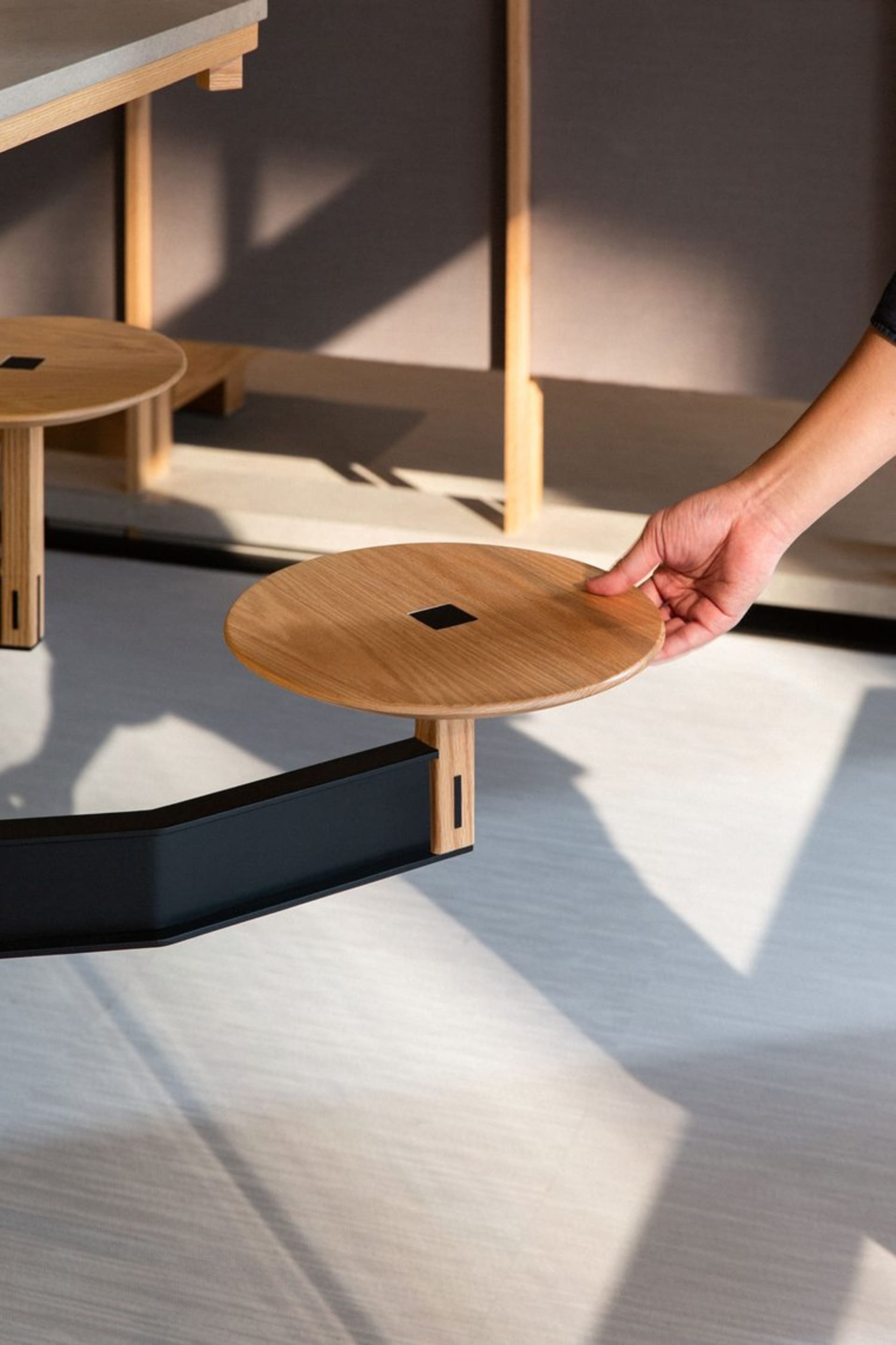 A sleek, modern, industrial-style side table made of wood.