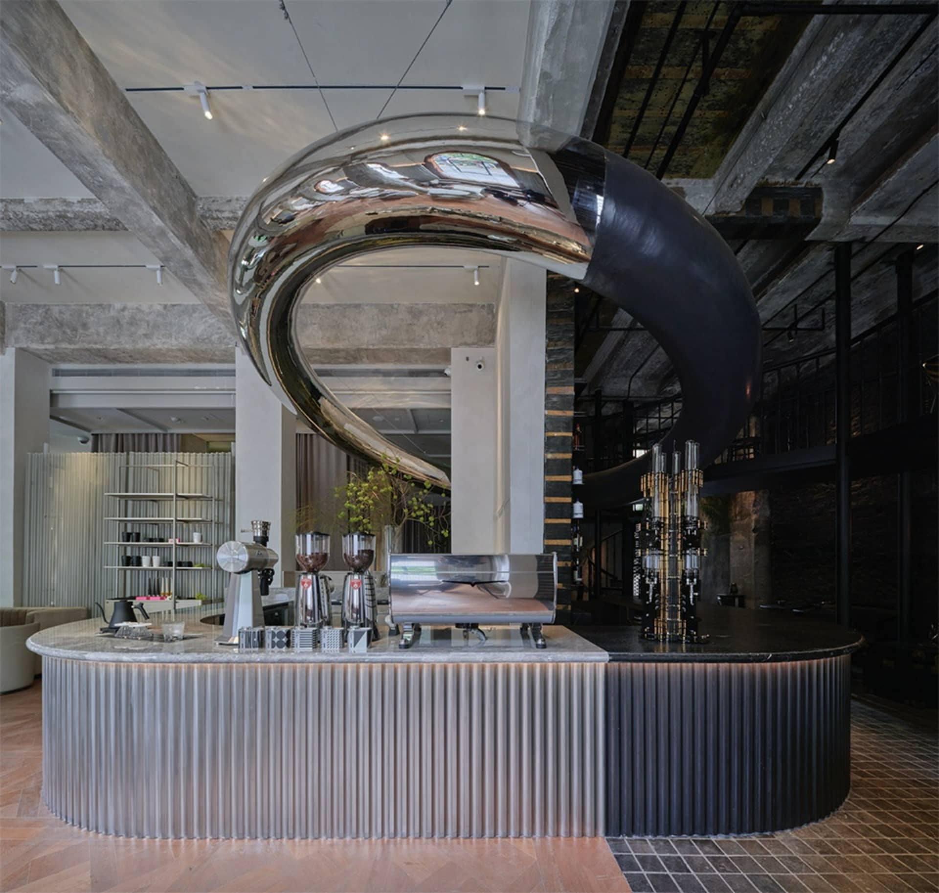 A modern bar with metal and concrete finishes.