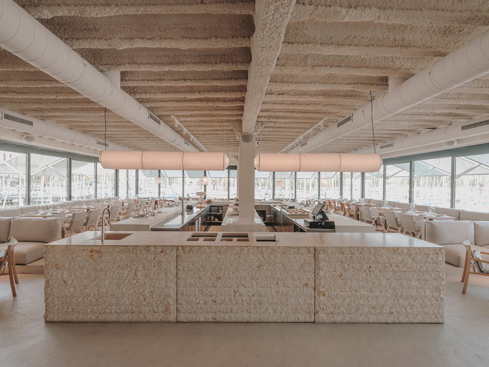 A modern restaurant interior with stone and concrete materials.