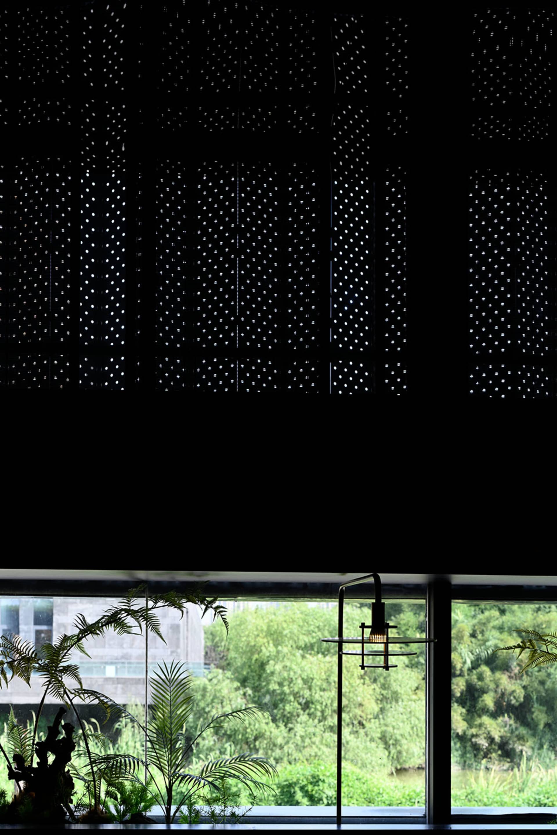 Modern minimalist interior design with large glass windows and plants.