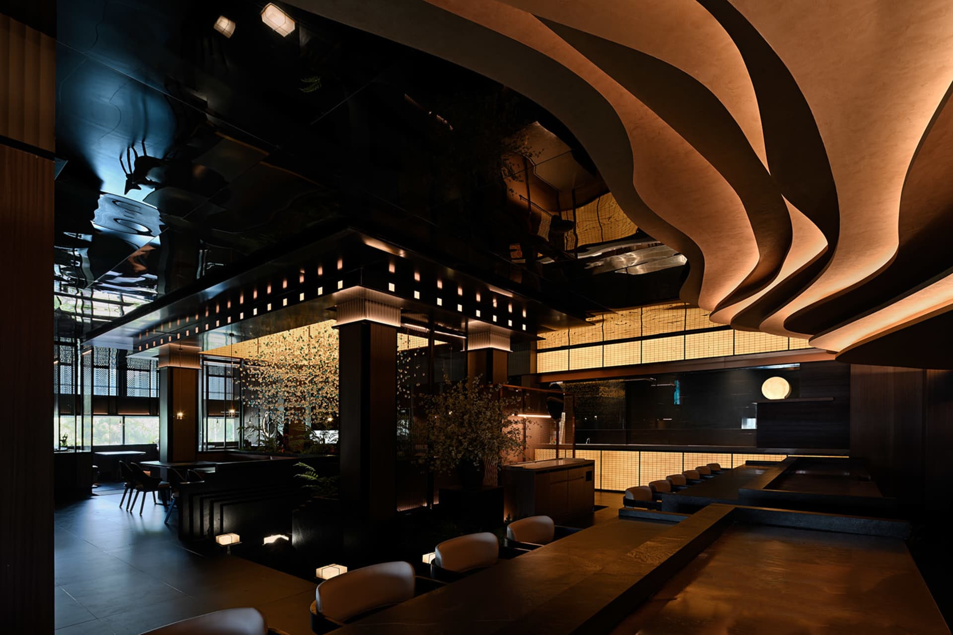 Modern restaurant interior with metallic, glass, and wooden elements