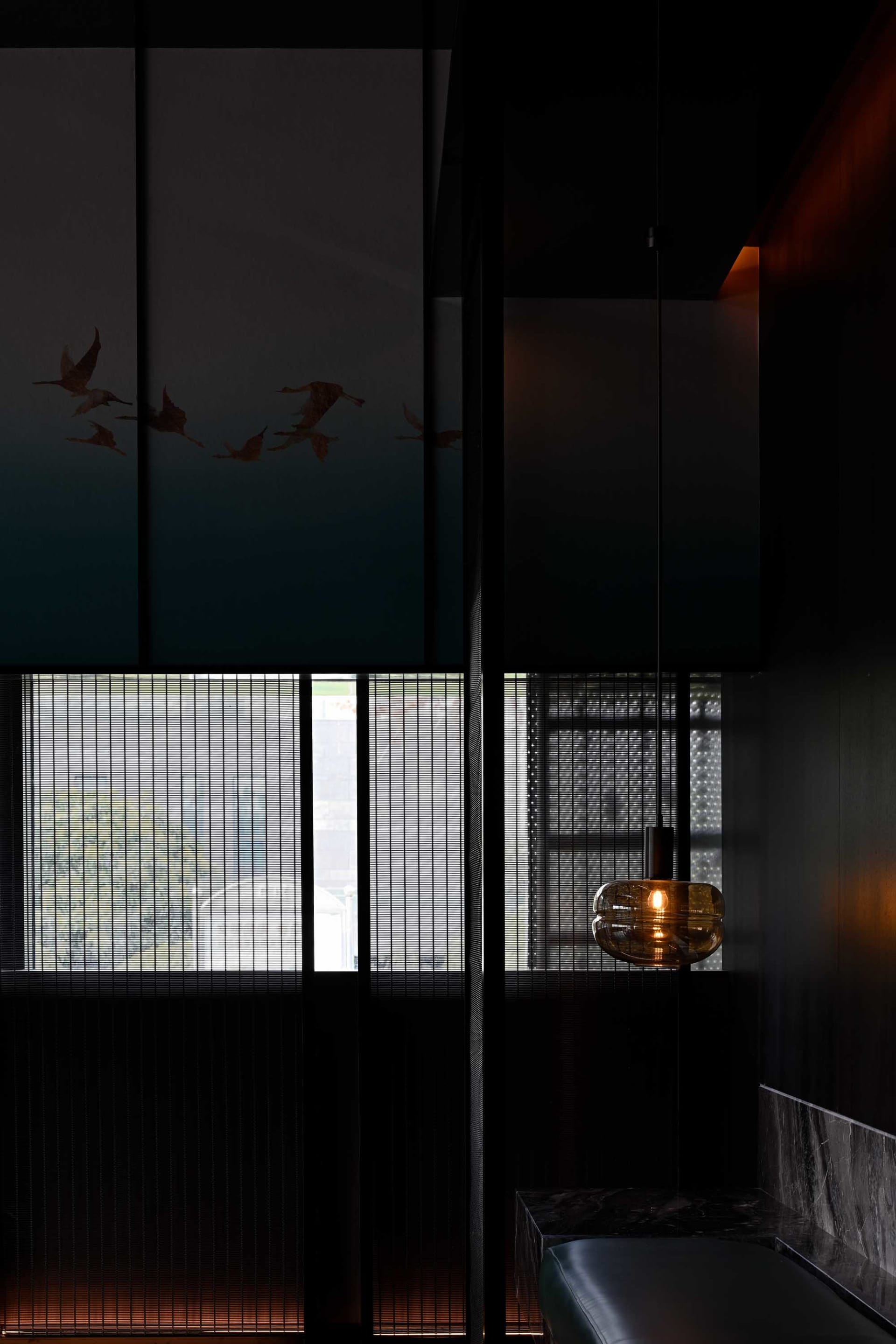 A minimalist interior design featuring black lighting and metallic accents.