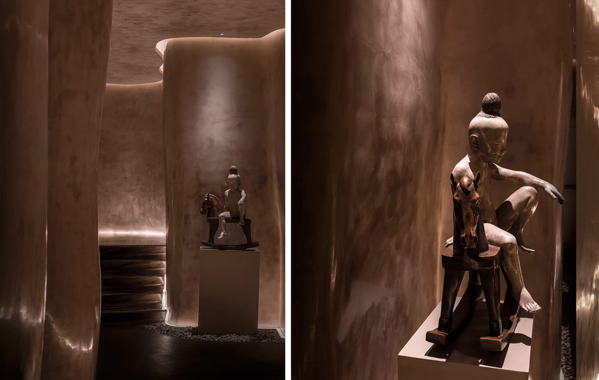 A bronze statue displayed in a modern interior setting.