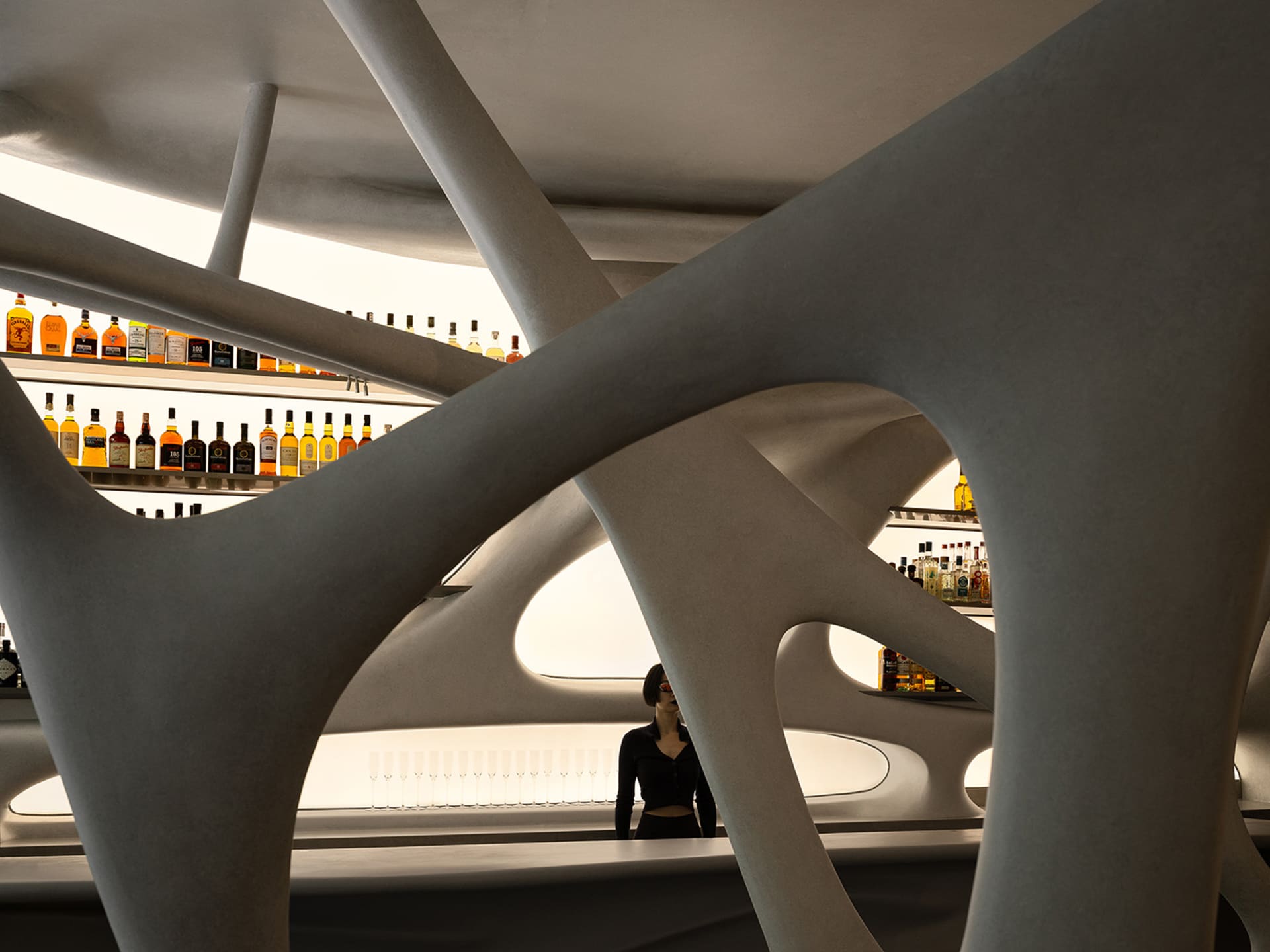 A sleek, modern bar interior with concrete structural elements, illuminated shelves showcasing a variety of bottles.