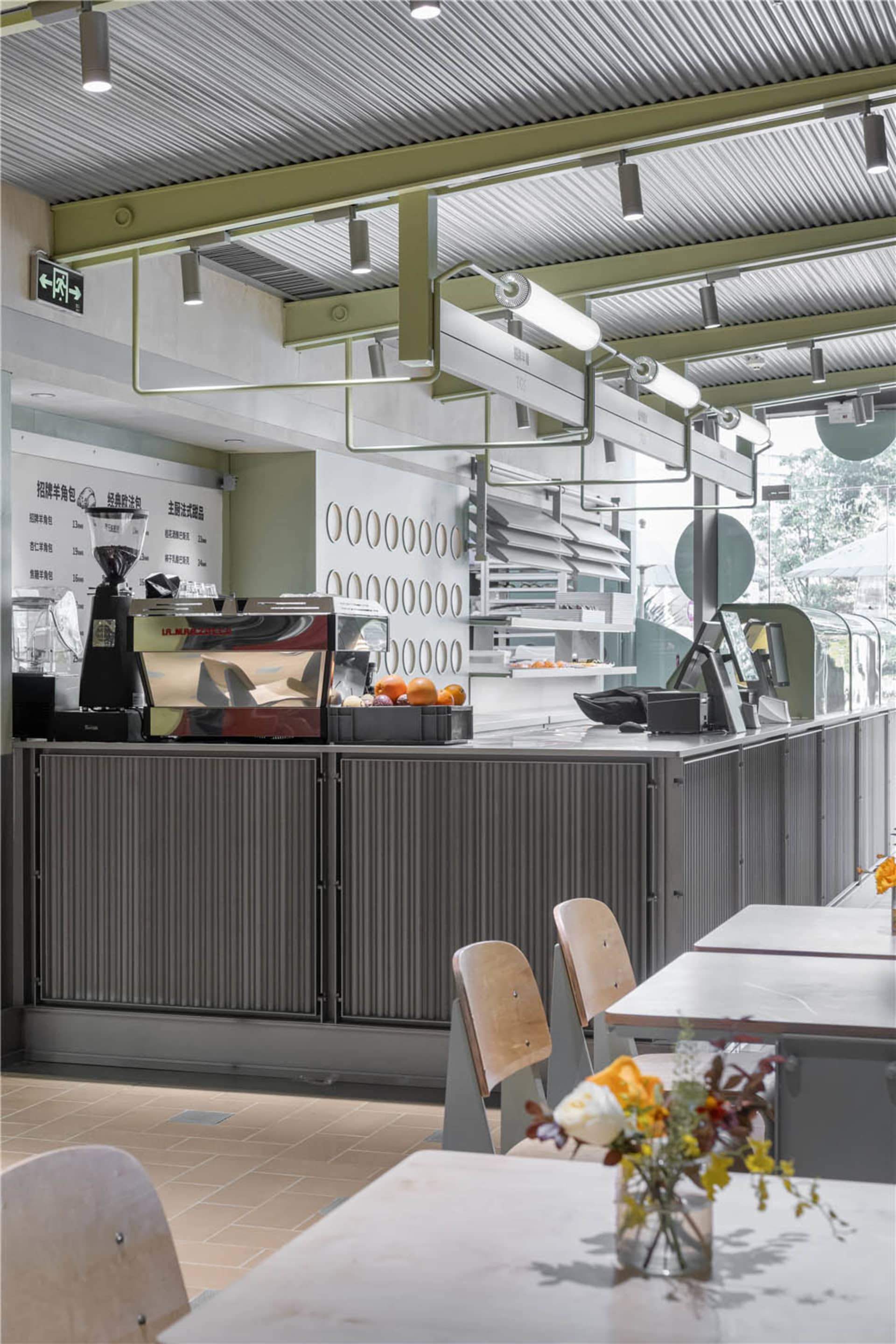 A modern cafe interior featuring a metallic counter.