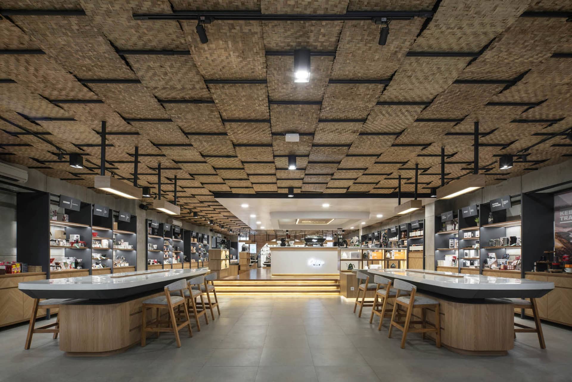 A cozy coffee shop features a unique bamboo ceiling design, providing a comfortable atmosphere for visitors.